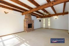 900 Kintore Rd Parkerville WA 6081 $1,050,000 Discover the perfect retreat on this stunning 5.07-acre native bush block, where tranquillity meets opportunity. Nestled at the end of a quiet cul-de-sac, this beautifully elevated 3×2 plus study or optional fourth bedroom brick and iron farmhouse-style home blends seamlessly into its natural surroundings. A meandering driveway leads you through the trees, unveiling a secluded sanctuary with a split-level floorplan, offering flexibility and charm. Enjoy the serenity of nature while still having the convenience of a powered workshop and 2.05 hectares of land, zoned RR1—providing exciting subdivision potential. Whether you’re seeking a peaceful lifestyle or an investment opportunity, this Parkerville gem offers privacy, space and endless possibilities. 3 bedrooms 2 bathrooms Plus study/4th bedroom 1980-built brick and iron Secluded bush setting High ceilings, exp beams AC, open fire, SC fireplace Central courtyard, patio 11m x 9m pw’d wkshop 5.07-acres with RR1 zoning Potential for subdivision Entry to this distinctive Perth Hills residence via a slate-tiled foyer, where arching jarrah steps and a gracefully curving wall announce a home unlike any other. This spacious multi-level property offers a unique layout, providing a canvas ready for your vision. The spacious kitchen and meals area, with a practical central island and twin electric wall ovens, provides a functional workspace where family dinners can be easily prepared. It is easy to imagine how this space could transform into an entertainer’s dream kitchen that becomes the true heart of this distinctive home. Adjacent is a generous mudroom/laundry with the potential to become a sophisticated scullery or butler’s pantry, enhancing both functionality and appeal for modern living. A versatile carpeted room with a slow-combustion fire and direct access to the sheltered patio could serve as an intimate snug on winter evenings, a dedicated library housing your collection or welcoming guest accommodation with its own entry. Teenagers will immediately recognise the potential for privacy here, with the adjoining office space completing a secluded domain away from the main living areas. The formal dining room overlooks a central courtyard, creating a sophisticated setting for dinner parties. Steps lead to a lateral family room with a quartet of tall windows that capture northwest light, complemented by an open fireplace for winter gatherings. Exposed beams and high ceilings accentuate the sense of volume in this central living area, while split-system air conditioning ensures year-round comfort. Slide open the glass door to access the central courtyard and indoor-outdoor living becomes seamless. The bedroom wing occupies a secluded section of the property, offering a peaceful retreat from daily activities. Three carpeted bedrooms, each appointed with built-in robes and individual climate control, provide comfortable accommodation for family or guests. The recently updated family bathroom presents a modern oasis with its soaking tub and double vanity, while a second WC off the laundry/mudroom offers practical convenience. The principal bedroom features its own ensuite. Step outside to discover the large, paved entertaining zone extending from the southern aspect of the home. Sheltered and edged with garden beds, this space invites long evenings of outdoor dining and conversation. Additional outdoor retreats include a charming gazebo and the central courtyard, each offering different perspectives to appreciate the natural beauty surrounding the home. The 11m x 9m powered workshop at the upper boundary, with a 4m high entry clearance is accessible via a pair of gates, serves practical needs well. With its concrete floor, lean-to and dedicated storage room, this multipurpose space is ready for your hobbies, projects or additional vehicle storage. As compelling as the home’s unique design is the 5.07-acre lot itself – a natural sanctuary of eucalypts, she-oak, zamia and seasonal wildflowers. The RR1 zoning presents a significant opportunity for subdivision, allowing you to maintain your private retreat while potentially capitalising on the development potential. This property represents a rare combination of immediate liveability and the promise of transformation into one of Perth Hills’ most notable residences—a chance to create a landmark home that perfectly balances architectural interest with the natural splendour of its setting.