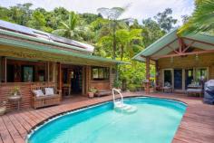265 Jackson Road Shell Pocket QLD 4855 $750,000 "Rum Jungle" as it's affectionately named, is a secluded, yet not remote rainforest hideaway just 20 minutes from the tropical paradise of Mission Beach. Approximately 4 acres of this 8 acre (3.35 ha) property is cleared to form lush tropical gardens, lawns and a 2 story home, freestanding extra bedroom/office, pool, garaging for 5 vehicles and an authentic Balinese hut. Access is via a bitumen rural road and a good all weather gravel road through tunnels of lush rainforest. Cairns Domestic and International Airport is 90 minutes north along National Highway 1. Within a radius of 10 - 20 mins travel there are the following amenities: The El Arish Tavern, Roadhouse (under construction), beautiful golf course, 14 km coastal strip of Mission Beach with its Clump Point Boating Harbour and 12 tropical islands (including Dunk and Bedarra), coral reefs, Post Office and Shops. "Rum Jungle "is off grid with the latest (6-month-old) 9 KVA solar system including battery storage plus a 5 KVA system with its own battery storage as well ...all sufficient to power air conditioning, washing machine, pool pump, power tools etc Other features of this remarkable property include: - Freehold acreage with estimated 300-400 m of permanent creek frontage( Maria Creek) and frontage to State Forest. - 20 - 30 mins to doctors, hospitals and services (in Mission Beach, Tully or Innisfail) -The major provincial town Innisfail is approx.. 40 minutes to the north and Tully approx. 20 mins to the south - Exotic all timber and steel construction of improvements - Pool side office/bedroom and sunroom - Furniture and machinery available including tractor, implements, generators, pumps, power tools and more - 6 water tanks provide more than adequate quality water from pristine Maria Creek - A selection of tropical fruit trees including clumps of delicious Cavendish Banana trees are spread throughout the property. "Rum Jungle" is a nature lovers paradise with a fascinating array of native animals including the giant Cassowary, colourful pigeons, vibrant butterflies, platypusses, wallabies and numerous bird species. Absolutely stunning neighbourhood of valleys and rainforest clad mountain ranges. Only a handful (about 6) owners share this stunningly beautiful valley, all on private small acreages. Crystal clear swimming holes and white sandy riverbanks are at your disposal to cool off. Extremely private, quiet and serene location. The Property is located on a "no through" road (Jackson Rd (North) towards the head of a spectacular valley. The access road is maintained by the local Shire Council. This property is seriously for sale as the owners have a firm commitment to buy a property interstate. It is an extremely rare find! Time to Plan your Escape! Don't Miss Out!