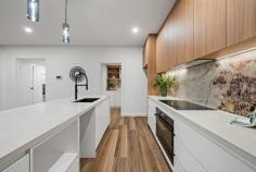 44 Robin Boyd Crescent TAYLOR ACT 2913 $1,100,000 Surrounded by nature reserves and nestled in the growing suburb of Taylor, this sophisticated 'as new' home has a lot to offer a large family. Its functional, modern design ensures low maintenance living, and its proximity to schools, shops and Canberra CBD, means less time commuting and more time relaxing. Built for comfort, style and functionality, neutral tones, timber look floors and thoughtful modern lighting provide a warming ambiance throughout this home. There is an open plan living and dining room and central executive style kitchen, which features stunning marble glass splash back, stone bench, exquisite fittings, sleek cabinetry, stainless steel oven, induction cooktop, and a walk-in butler's pantry. All season entertaining is invited in the formal lounge with an elegant electric gas fireplace and a covered outdoor alfresco terrace with servery, sink and barbecue. Also on the lower level is a third guest bathroom, fourth bedroom with robe, and laundry with external access. Upstairs, there are two more generous sized bedrooms with robes, a stylish family bathroom with separate shower, edgeless tub and WC, and an additional sitting room perfect for a children's retreat, studying or reading nook. The master suite is a haven offering built in cabinetry with a stone bench, walk-in robe, private balcony and luxurious ensuite complete with large shower, twin sinks, LED lighted mirrors and heated towel rack. Functional features of the home include air-conditioning, ducted heating, ample storage, security system, easy care fenced yard and two car garage with internal access. Taylor offers relaxed weekends perfect for family living. Explore nearby nature reserves, get active at Taylors adventure playground, discover local bike tracks or simply chill at home in one of the many spacious living zones. Conveniently located, this home is minutes to local schools, Amaroo Village Shopping Centre, Gungahlin town centre and Casey Market Town, and there is plenty of public transport on the doorstep including light rail to the CBD. Taylor is a growing suburb with several developments in the works including a government high school, two sporting fields and additional shops. Be quick to view this incredible family home in a family friendly community. Features - 'As new' modern family home in convenient location Bright open plan kitchen, living and dining room Executive style kitchen and walk in butler's pantry Formal lounge with contemporary electric fireplace Alfresco entertaining area with sink and servery Three robed bedrooms and stylish family bathroom Master suite with luxurious ensuite and walk in robe Balcony from master suite and upstairs sitting room Additional downstairs bathroom and large laundry Air-conditioning, ducted heating and ample storage Fully fenced, easy care backyard in quiet leafy street Two car garage with internal access, security system Close to local schools, shops, parks, nature reserves Minutes to Gungahlin town centre, 25 minutes to CBD