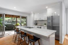 52-54 Parkes Street Helensburgh NSW 2508 $1,200,000 Welcome to 52-54 Parkes Street, Helensburgh - a delightful family home offering serene bush views. This inviting three bedroom residence features a master suite with a chic ensuite, and glass sliding doors that open onto a spacious deck, the perfect spot to enjoy your morning coffee. All three bedrooms offer built in robes and there is a bonus dressing room/home office off the master. The sun-drenched living area and dining area highlights the peaceful surroundings, and the stunning kitchen serves as the heart of the home, boasting an island bench, ample storage and generous bench space. Reverse cycle airconditioning and combustion fireplace ensures year round comfort. Set on a 1008m² block, the property includes tiered gardens with a variety of native trees and a lush lawn, adding to its charm. Relax on the deck, ideal for entertaining, and take in the views of the adjacent bushland, which is designated environmental land, ensuring your privacy. The home also features a single car garage, off street parking and is conveniently located within walking distance to schools, shops, and the railway station. This beautiful home is ready for you to move in and enjoy. A visit is a must to fully appreciate all it has to offer. Three bedrooms all with built in robes Modern family bathroom and chic ensuite Glass doors from both the master bedroom and living area to alfresco deck Stunning kitchen with island bench and ample storage and bench space Polished floorboards throughout living areas Airconditioning and combustion fireplace for year round comfort 1011.7 m2 parcel of land with tranquil bush outlook Walking distance to local schools and train station