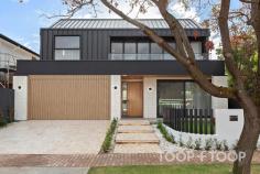 1 Brunswick St Walkerville SA 5081 $3,750,000 A showpiece of contemporary luxury, this brand-new architectural masterpiece situated in one of Adelaide’s premier suburbs is a standout property on today’s market. Two expansive levels celebrate high-end design, with sumptuous interiors, top of the range fixtures and magnificent north facing alfresco spaces ticking every box. ENTRANCE The impressive street presence is a showpiece of bold industrial-style minimalism softened by sandstone paving and lawn. A series of floating platforms rise to the front porch and two car-garage concealed behind a remote wood batten door The sensational first impression carries right the way through. Stunning oak herringbone floors, soaring ceilings, full height glass overlooking courtyards, and fluid architectural curves including a magnificent custom staircase provide a sophisticated aesthetic filled with comfort and light. GALLERY HALLWAY AND STAIRCASE Punctuated by a picture window that frames an internal courtyard and glorious olive tree, the gallery style hallway stretches past a glamorous powder room towards wow-factor open plan living. The sculptural staircase sweeps skywards, with a soaring circular skylight bathing the lower floor with light. At the top of the stairs, one is greeted by another wall of glass that virtually floats over the courtyard below. OPEN PLAN LIVING This monumental space is a triumph of effortless contemporary style, and incorporates a sensational suspended fireplace, a study spilling through to a north facing courtyard, and a bank of glass bifold doors that provide an uninterrupted link to alfresco entertaining and the pool. Overlooking casual meals and living, the kitchen, central island bench and wrap through pantry have been designed for the family entertainer to welcome friends and family. Custom joinery hosts a range of Miele appliances, extensive storage and wine display. LIVING RETREAT AND THEATRE ROOM Upstairs, versatile extended living caters for a range of activities for the whole family to enjoy. A theatre room with an elevated seating platform, a kitchenette, dark walls and feature lighting will ensure a cinematic experience. A versatile light filled living retreat that overlooks the lower courtyard, provides a great space for the kids to relax, or a cosy spot to curl up with a book and a coffee. FOUR BEDROOM SUITES The epitome of luxurious high-end design, the breathtaking master sanctuary is truly next level. The vast bedroom with built in robes and a high vaulted ceiling is large enough to incorporate its own living retreat that spills out to a balcony with treetop views towards the hills. Behind a blade wall, built-in robes stretch down either side of two passages that form his and hers walk-in robes. To one side a dedicated shower room and to the other a WC room. Where the two sides meet, the luxurious bathroom incorporates a curved wall with an indulgent round tub and double vanities. Two further bedrooms that share a designer bathroom include their own walk-in robes. Downstairs, a private bedroom with a glamorous ensuite is perfect for guests, the teen, young adult or extended family member. OUTDOOR LIVING & POOL Bifold doors open to combine indoor and outdoor living that includes a kitchen with sink and Beefeater BBQ. Bathed in north facing sunshine, the fully tiled and heated pool is embraced by a low maintenance rear lawn and garden, whilst an outdoor shower and WC mean no wet feet need come inside. KEY FEATURES POOL • Solar heated • Saltwater chlorination • Glass fence • Outdoor shower & WC GARDEN • Automatic irrigation with wi-fi control • Garden lighting APPLIANCES • Miele ovens, gas cooktop & dishwasher • Vintec wine fridge in theatre room • Beefeater BBQ COMFORT • Ducted reverse cycle air-conditioning • Suspended Zen Elegante Fireplace • Alfresco ceiling fan • Automated sheers PARKING • Remote entry 2 car garage + additional driveway parking • Internal entry to mudroom & laundry LOCATION: Exclusive city-fringe less than 6 km from Victoria Square SCHOOLS: Coveted zoning to Adelaide Botanic & Adelaide High Schools; Walkerville Primary School. Walk to Wilderness School & St Andrews. Close to PAC & St Peters College SHOPPING: Walkerville Terrace, Melbourne Street & O’Connell Street cosmopolitan shopping & cafes RECREATION: Walk to Walkerville Oval, Memorial Gardens & Bowling Club. Close to Linear Park & parklands