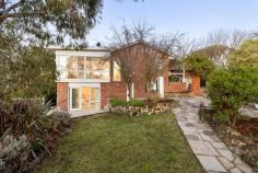 24 Fenton Crescent Frankston South VIC 3199 $1,150,000 - $1,265,000 Embrace the serene charm of Frankston South in this enchanting four-bedroom home, where lush native outlooks meet the soothing melodies of native birdsong. Nestled on a generous 1,482sqm (approx.) beachside block, its gentle sloping surroundings marry with Sweetwater Creek just behind. A distinctive living experience awaits in this thoughtfully crafted dual-level design, where treetop views take centre stage. The circular layout beautifully merges formal and informal living and dining spaces around a practical kitchen, creating a harmonious family environment. Enriched by the cosy crackle of two fireplaces, the atmosphere radiates warmth and character, while a rear bank of windows bathes the secondary living area in the soft glow of winter sun. Four spacious bedrooms and two light-filled bathrooms cascade across the layout, each reflecting their own unique personality, while all offering tranquil outlooks and adequate storage. Solid timber floors and large windows throughout celebrate the home's charm, while added features continue with a dedicated laundry with external access, an Actron Air cooling system, gas ducted heating, solar power with a Tesla battery, and rain water tanks. A circular driveway with rear double garage frames the established gardens and sun-drenched patio, while an enclosed veggie garden and rear chicken coop offer sustainable living options. Positioned within the Frankston High School Zone, with easy walking distance to Frankston Beach and public transport, with Frankston Hospital, Beauty Park, and Bayside Shopping Centre just moments from home.