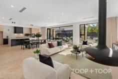 1 Brunswick St Walkerville SA 5081 $3,750,000 A showpiece of contemporary luxury, this brand-new architectural masterpiece situated in one of Adelaide’s premier suburbs is a standout property on today’s market. Two expansive levels celebrate high-end design, with sumptuous interiors, top of the range fixtures and magnificent north facing alfresco spaces ticking every box. ENTRANCE The impressive street presence is a showpiece of bold industrial-style minimalism softened by sandstone paving and lawn. A series of floating platforms rise to the front porch and two car-garage concealed behind a remote wood batten door The sensational first impression carries right the way through. Stunning oak herringbone floors, soaring ceilings, full height glass overlooking courtyards, and fluid architectural curves including a magnificent custom staircase provide a sophisticated aesthetic filled with comfort and light. GALLERY HALLWAY AND STAIRCASE Punctuated by a picture window that frames an internal courtyard and glorious olive tree, the gallery style hallway stretches past a glamorous powder room towards wow-factor open plan living. The sculptural staircase sweeps skywards, with a soaring circular skylight bathing the lower floor with light. At the top of the stairs, one is greeted by another wall of glass that virtually floats over the courtyard below. OPEN PLAN LIVING This monumental space is a triumph of effortless contemporary style, and incorporates a sensational suspended fireplace, a study spilling through to a north facing courtyard, and a bank of glass bifold doors that provide an uninterrupted link to alfresco entertaining and the pool. Overlooking casual meals and living, the kitchen, central island bench and wrap through pantry have been designed for the family entertainer to welcome friends and family. Custom joinery hosts a range of Miele appliances, extensive storage and wine display. LIVING RETREAT AND THEATRE ROOM Upstairs, versatile extended living caters for a range of activities for the whole family to enjoy. A theatre room with an elevated seating platform, a kitchenette, dark walls and feature lighting will ensure a cinematic experience. A versatile light filled living retreat that overlooks the lower courtyard, provides a great space for the kids to relax, or a cosy spot to curl up with a book and a coffee. FOUR BEDROOM SUITES The epitome of luxurious high-end design, the breathtaking master sanctuary is truly next level. The vast bedroom with built in robes and a high vaulted ceiling is large enough to incorporate its own living retreat that spills out to a balcony with treetop views towards the hills. Behind a blade wall, built-in robes stretch down either side of two passages that form his and hers walk-in robes. To one side a dedicated shower room and to the other a WC room. Where the two sides meet, the luxurious bathroom incorporates a curved wall with an indulgent round tub and double vanities. Two further bedrooms that share a designer bathroom include their own walk-in robes. Downstairs, a private bedroom with a glamorous ensuite is perfect for guests, the teen, young adult or extended family member. OUTDOOR LIVING & POOL Bifold doors open to combine indoor and outdoor living that includes a kitchen with sink and Beefeater BBQ. Bathed in north facing sunshine, the fully tiled and heated pool is embraced by a low maintenance rear lawn and garden, whilst an outdoor shower and WC mean no wet feet need come inside. KEY FEATURES POOL • Solar heated • Saltwater chlorination • Glass fence • Outdoor shower & WC GARDEN • Automatic irrigation with wi-fi control • Garden lighting APPLIANCES • Miele ovens, gas cooktop & dishwasher • Vintec wine fridge in theatre room • Beefeater BBQ COMFORT • Ducted reverse cycle air-conditioning • Suspended Zen Elegante Fireplace • Alfresco ceiling fan • Automated sheers PARKING • Remote entry 2 car garage + additional driveway parking • Internal entry to mudroom & laundry LOCATION: Exclusive city-fringe less than 6 km from Victoria Square SCHOOLS: Coveted zoning to Adelaide Botanic & Adelaide High Schools; Walkerville Primary School. Walk to Wilderness School & St Andrews. Close to PAC & St Peters College SHOPPING: Walkerville Terrace, Melbourne Street & O’Connell Street cosmopolitan shopping & cafes RECREATION: Walk to Walkerville Oval, Memorial Gardens & Bowling Club. Close to Linear Park & parklands