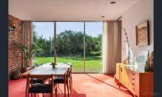 2 Mccolls Way Portsea VIC 3944 $11,000,000 - $12,000,000 Perfectly positioned on the sands of Shelly Beach, this north-facing residence overlooks Port Phillip Bay with spectacular views. Built from concrete and brick in the 1960s, it sits in a quiet cul-de-sac on McColl's Way alongside just two other properties, on 1262sqm of land that opens through a tea-tree canopy directly onto the beach. A wide entrance foyer leads to an open-plan formal lounge and dining room, plus an informal sitting room with adjoining kitchen. Upstairs, five bedrooms and two ensuite bathrooms all open to a generous balcony overlooking the water. Additional features include a carport for two cars and a double lock-up garage.