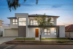 6 Windsor Ave Clovelly Park SA 5042 $1,350,000 - $1,450,000 Spread over two superb levels of unrivalled contemporary living, this Hoppen Group build offers the best of brand new, with plenty of room to move and park views. Its wide clean-lined façade creates a commanding street presence, but it's what's on the inside that counts; a grand front entrance certain to make a fine first impression. Double doors reveal a light-filled open plan heart of the home, where the sleekest of kitchens overlooks dining and living spaces with sliding doors onto an alfresco entertaining space under the main roof. Dark cabinetry adds warmth as well as infinite storage space to the stunning kitchen, where a 5-burner gas cooktop, oven, dishwasher, huge island with breakfast bar and Caesarstone benchtops blend practicality with luxury. Also on the ground floor, a most comfortable bedroom with walk-through robe and spacious ensuite with frameless shower, matte black tapware and accessories and full-height tiling presents an invaluable master option or perfect guest room. Upstairs, a further three bedrooms include another incredible master option; this one flooded with natural north-easterly light, huge walk-through robe and enormous ensuite with dual sink vanity and freestanding bath as well as shower. Bedrooms three and four are serviced by a third bathroom with shower, vanity and toilet. Also on the upper level, a priceless second living space with private balcony overlooking Kensington Reserve ensures plenty of legroom as well as fantastic views and fresh air. We love: - Ducted reverse cycle air conditioning. - Huge laundry lined with full-height hidden storage. - Ground floor powder room. - Double automatic garage with internal access. - Study nook to entry + under stair storage. - Mirrored built-in robes to bedrooms 3 & 4. - Secure low maintenance courtyard. Directly adjacent the Kensington Street Reserve, you'll find the bus, train, Mitchell Park Oval and Clovelly Park Primary School within easy walking distance, with easy access to Westfield Marion, the Tonsley precinct and Flinders University, just 10kms from the CBD and even less to the sea. From its high-quality finishes to its plentiful park views, you'll love calling Windsor Avenue 'home'