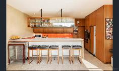 2 Mccolls Way Portsea VIC 3944 $11,000,000 - $12,000,000 Perfectly positioned on the sands of Shelly Beach, this north-facing residence overlooks Port Phillip Bay with spectacular views. Built from concrete and brick in the 1960s, it sits in a quiet cul-de-sac on McColl's Way alongside just two other properties, on 1262sqm of land that opens through a tea-tree canopy directly onto the beach. A wide entrance foyer leads to an open-plan formal lounge and dining room, plus an informal sitting room with adjoining kitchen. Upstairs, five bedrooms and two ensuite bathrooms all open to a generous balcony overlooking the water. Additional features include a carport for two cars and a double lock-up garage.