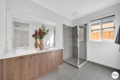5 Bruhn Street Clyde Morth VIC 3978 $849,000 - $899,000 Beautifully crafted with a focus on comfort and quality, this stunning, brand-new east-facing home offers 25 squares of spacious, thoughtfully designed living. From the moment you step inside, the design reveals itself with a formal lounge - perfect for entertaining or a quiet retreat - before double doors lead you into the grand master suite. This retreat is appointed with His and Hers walk-in robes and a luxurious ensuite featuring a Caesarstone benchtop, freestanding bathtub, dual vanities, oversized shower, and a heated towel rail. A home office/study precedes the true heart of the home - a light-filled open-plan living and dining zone, seamlessly connecting to the undercover alfresco with extended decking. This outdoor haven is ideal for year-round entertaining, with ample space for children and pets. The chef's kitchen showcases Caesarstone benchtops, stone splashback, stainless steel appliances, a 900mm oven with gas cooktop, microwave and dishwasher, plus abundant storage and a walk-in pantry. A large linen cupboard and well-designed laundry add to the home's practicality. The private rear wing includes a second master-size bedroom, two additional bedrooms with built-in robes, a family bathroom with a stunning freestanding bathtub tub and a separate WC. UPGRADED INCLUSIONS • LED lighting - doubled in all rooms and living areas • Additional power points throughout • Double-glazed windows in all living areas and bedrooms • Evaporative cooling & Ducted heating • Blockout roller blinds & flyscreens • Heated towel rail and freestanding bathtub to main bathroom • Double vanity with special order floor-mounted spout and hand shower • 900mm oven & gas cooktop • Microwave oven and dishwasher included • Premium underlay (11mm Dunlop Imperial Plus) for carpet & laminate flooring • 2.7m ceilings and high internal doors LOCATION & LIFESTYLE When good schooling matters, Clyde Grammar is just a short walk away. With low-maintenance landscaping already completed, all that's left is to move in and enjoy.