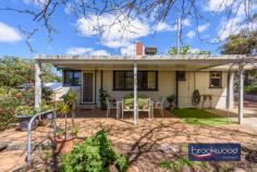 4 Narla Pl Koongamia WA 6056 $639,000 Nestled at the quiet end of a cul-de-sac, this charming 1950s cottage captures the essence of relaxed foothills living. Set on a generous 878-square-metre block with sub-divisible potential, the home is framed by cottage-style gardens that create an inviting sense of arrival. 3 bedrooms 1 bathroom 1959-built Fibro and tile Jarrah floor high ceiling OP kitchen/meals w AC Formal lounge w SC fire Freshly painted through Ducted evap + 2 splits 878 sqm block R20/35 Shed/storage/OS parking A pathway travels through established plantings to the welcoming front verandah of this impressive Koongamia home. Inside, original jarrah floors and high ceilings speak to the home’s heritage, creating spaces that feel both gracious and grounded. The formal lounge, anchored by a slow combustion fire fitted into the original fireplace, offers a cosy retreat, its large west-facing window framing leafy garden views. A sliding door connects this room to the open-plan kitchen and meals area, where white and grey cabinetry, a freestanding electric oven and split-system air conditioning combine to create a bright, functional hub for daily living. A door opens from the kitchen to the front verandah, introducing an easy indoor-outdoor flow perfect for casual alfresco dining as the day winds down. To the rear of the kitchen, a generously proportioned walk-through laundry leads to a wide east-facing verandah overlooking cottage gardens, blossom and trees that fill the backyard with seasonal colour. The principal bedroom is situated at the front of the home, where generous proportions, a picture window, and a lofty ceiling create an airy, light-filled retreat. Garden views through the window bring a sense of calm, while carpet underfoot and split-system air conditioning ensure year-round comfort. Two additional bedrooms offer flexible accommodation. The rear room features an east-facing window with garden aspects, while the second junior bedroom provides ample space for a double bed. Both bedrooms have polished jarrah floors. The shared family bathroom has been thoughtfully updated with full tiling, a walk-in shower, vanity and built-in storage, while a separate WC adds practical convenience. Beyond the back door, the property reveals its authentic charm. The rear garden is a generous, sun-dappled space where mature trees offer shade and cottage-style plantings soften the boundaries. It’s the kind of yard that invites weekend mornings with a book, summer barbecues and the simple pleasure of watching the seasons change. The Heritage Trail runs along the side boundary, offering hours of walking and riding amidst the natural beauty of the Perth Hills. The top-of-the-cul-de-sac position ensures peace and privacy without sacrificing accessibility. Koongamia strikes a rare balance – a foothills suburb with genuine character, and practical access to Midland, public transport and Perth Airport, keeping the city within easy reach. This cottage embodies that balance perfectly: original charm and modern convenience, generous gardens and subdivisible potential, quiet comfort and connected living. For those seeking a character home with flexibility, space and a location that truly delivers, this is an opportunity worth seizing.