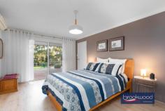 45 Strawberry Hill Dr Gidgegannup WA 6083 $1,000,000 Set amongst a landscape of gently contoured pastures and majestic gums, this two-storey Ross Squires home is a rural idyll writ large, offering a rare opportunity for fellow equestrian enthusiasts to continue a passionate legacy of horsemanship. As you arrive at the fully fenced property and approach the north-facing front door, a sense of calm descends—a feeling that only deepens as you discover the thoughtful marriage of contemporary architecture with serious equestrian infrastructure. 4 bedrooms 2 bathroom 2011-built Hardi and iron Open plan living/kitchen First-floor junior zone Barn, stable, tack, feed Round yard & arena 8 paddocks & wash bay Rainwater tanks & bore 4.94-acre pasture perfect Rural luxury horse haven Step inside, and your eyes are immediately drawn to the lush rural views framed by large windows and a sliding glass door that opens to the paved alfresco entertaining area, set under the main roof. This blissful outdoor living and entertaining space is edged with a drought-tolerant sand garden planted in a series of Corten steel beds, creating a sophisticated transition between interior comfort and the pastoral beauty beyond. Large tiles extend across much of the ground floor plan, their light, neutral tone bringing a sense of cohesion and a flexible backdrop to the embellishments of your life, whether that includes muddy riding boots or elegant dinner parties. To the right of the central living zone is a meals area and kitchen that speaks to both daily practicality and weekend entertaining. The kitchen, a modern delight, uses a limited palette of materials in predominantly soft white tones. Stone benchtops and an embarrassment of overhead and under-bench storage – including appliance nooks –surround the electric oven, four-burner gas hob and dishwasher. A corner window dressed in plantation shutters frames glimpses of surrounding paddocks, ensuring that even whilst preparing meals, the connection to the equestrian landscape remains unbroken. Judiciously positioned on the ground floor, away from the hustle and bustle of the junior bedrooms, the principal suite sits at the east end of the plan with a sliding door to the verandah, a sizeable walk-in robe and dressing room, and a fully tiled ensuite with a double shower, a central vanity with stone top and a separate WC. Split air conditioning delivers year-round comfort. A powder room and walk-through laundry with a wall of built-in storage complete the layout of the ground floor. Timber stairs ascend to the first floor, a fantastic space for children where three bedrooms open off a generous central living room with access to a south-facing balcony. Each of the junior bedrooms is carpeted and fitted with mirrored robes, with one opening to a private balcony and views towards Susannah Brook that will inspire young riders’ dreams of adventure. A treetop home office with built-in storage and a spectacular cathedral window hums with ample light and delightfully distracting views. The perfect space for homework, managing family admin, or simply watching the dancing canopy of majestic gums. The current owner, a passionate horsewoman, has developed and maintained a suite of facilities that represent a serious commitment to equine pursuits. Eight paddocks, the majority of which have electric fencing, and two with shelters, provide flexible grazing and turnout options. At the same time, powered stables with two four-metre by four-metre stalls, covered walk-out yards, a feed and tack room, and a wash-down bay with a dedicated hot water supply offer both horse and rider superior accommodation. The arena and round yard complete a setup that speaks to dedication and understanding of equestrian needs – this is infrastructure built by someone who truly knows horses. Avalon built both the stables and the drive-through barn, with the latter featuring high clearance for float storage, a bathroom/laundry with a heavy-duty machine for washing horse rugs, and a small kitchenette which opens onto a paved. A 9×6-metre garage provides secure parking and extra storage, complementing the equestrian facilities and adding to the property’s practicality. Surrounded by properties of a similar size and neighbours with an equine bent, Strawberry Hill offers a rural escape within easy reach of both Mundaring and Midland, just 30 minutes from the airport and a commutable 40 minutes from the Perth CBD. This ensures that while you enjoy the peace of country living, urban amenities remain accessible. Rainwater tanks with a filter at the house, rainwater tanks at the stable complex, and a bore with a small tank give you peace of mind in the Australian climate, as does the fire suppression system on the roof. This is a property where every detail has been considered, not just for comfortable living, but for the specific needs of those whose lives revolve around horses. It understands that the view from the kitchen window is made infinitely more beautiful by horses grazing in the morning light.