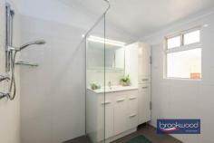 4 Narla Pl Koongamia WA 6056 $639,000 Nestled at the quiet end of a cul-de-sac, this charming 1950s cottage captures the essence of relaxed foothills living. Set on a generous 878-square-metre block with sub-divisible potential, the home is framed by cottage-style gardens that create an inviting sense of arrival. 3 bedrooms 1 bathroom 1959-built Fibro and tile Jarrah floor high ceiling OP kitchen/meals w AC Formal lounge w SC fire Freshly painted through Ducted evap + 2 splits 878 sqm block R20/35 Shed/storage/OS parking A pathway travels through established plantings to the welcoming front verandah of this impressive Koongamia home. Inside, original jarrah floors and high ceilings speak to the home’s heritage, creating spaces that feel both gracious and grounded. The formal lounge, anchored by a slow combustion fire fitted into the original fireplace, offers a cosy retreat, its large west-facing window framing leafy garden views. A sliding door connects this room to the open-plan kitchen and meals area, where white and grey cabinetry, a freestanding electric oven and split-system air conditioning combine to create a bright, functional hub for daily living. A door opens from the kitchen to the front verandah, introducing an easy indoor-outdoor flow perfect for casual alfresco dining as the day winds down. To the rear of the kitchen, a generously proportioned walk-through laundry leads to a wide east-facing verandah overlooking cottage gardens, blossom and trees that fill the backyard with seasonal colour. The principal bedroom is situated at the front of the home, where generous proportions, a picture window, and a lofty ceiling create an airy, light-filled retreat. Garden views through the window bring a sense of calm, while carpet underfoot and split-system air conditioning ensure year-round comfort. Two additional bedrooms offer flexible accommodation. The rear room features an east-facing window with garden aspects, while the second junior bedroom provides ample space for a double bed. Both bedrooms have polished jarrah floors. The shared family bathroom has been thoughtfully updated with full tiling, a walk-in shower, vanity and built-in storage, while a separate WC adds practical convenience. Beyond the back door, the property reveals its authentic charm. The rear garden is a generous, sun-dappled space where mature trees offer shade and cottage-style plantings soften the boundaries. It’s the kind of yard that invites weekend mornings with a book, summer barbecues and the simple pleasure of watching the seasons change. The Heritage Trail runs along the side boundary, offering hours of walking and riding amidst the natural beauty of the Perth Hills. The top-of-the-cul-de-sac position ensures peace and privacy without sacrificing accessibility. Koongamia strikes a rare balance – a foothills suburb with genuine character, and practical access to Midland, public transport and Perth Airport, keeping the city within easy reach. This cottage embodies that balance perfectly: original charm and modern convenience, generous gardens and subdivisible potential, quiet comfort and connected living. For those seeking a character home with flexibility, space and a location that truly delivers, this is an opportunity worth seizing.