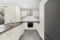 2/9 Windoo Street Frankston North VIC 3200 $610,000 - $671,000 Oozing modern comfort and laid-back sophistication, this beautifully designed single-level home is a celebration of style, functionality, and easy-care living, perfect for young families, downsizers, investors, or professionals craving low-maintenance luxury in a superbly connected location. Privately nestled behind a secure frontage with a soft coastal-inspired landscape, the home makes a striking first impression. A gallery-style hallway introduces a calming monochromatic palette and crisp contemporary finishes that carry throughout the home, leading the eye toward an expansive open-plan living, dining, and kitchen domain at the rear. Here, natural light floods the space through large windows and sliding glass doors, encouraging a seamless indoor-outdoor lifestyle. At the heart, a stone-bench kitchen with sleek cabinetry, quality stainless steel appliances, and a dishwasher forms the natural gathering point, ideal for both everyday living and entertaining. Whether hosting friends for a barbecue or relaxing with a coffee, the north-facing alfresco patio and low-maintenance garden deliver a tranquil extension of the interiors, framed by neat perimeter planting. Three generous bedrooms with built-in robes ensure private accommodation, headlined by a spacious master suite complete with a luxurious ensuite showcasing a rainmaker shower head. A central family bathroom and cleverly concealed European laundry add further practicality to the well-planned layout. Comfort is assured year-round with ducted heating and split system air-conditioning in the main living area. Additional features include a garden shed for extra storage, a water tank, and a double carport with a remote-controlled door providing secure off-street parking. Positioned within walking distance to parks, shops, public transport, and reputable local schools, and with easy access to Eastlink and Peninsula Link, this stylish residence offers unmatched convenience for daily life or weekend escapes. A short drive will take you to the stunning Seaford Foreshore Reserve, with the National Golf Club, Long Island, and Monterey Community Park just moments away. Whether you're searching for a move-in-ready first home, a secure downsize option, or a reliable investment in a high-demand pocket, this beautifully appointed home delivers on all fronts, balancing contemporary flair, smart design, and lifestyle appeal in one inviting package.
