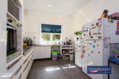 4 Afric St Middle Swan WA 6056 $649,000 An opportunity where family sanctuary meets strategic investment on a substantial 971 sqm block. This original 1950s residence offers the immediate rewards of generous family living alongside the long-term prospects of R20 development potential, subject to necessary approvals. An enviable position transforms a spacious family home into a truly strategic acquisition. Currently tenanted until April 2026. 3 bedrooms 1 bathroom 1953-built brick and tile Lounge sunroom & activity Updated central kitchen Sep games room and study High ceilings throughout Big backyard level fenced Pwd weatherboard garage 971 sqm block zoned R20 Behind a screen of clipped Lilly Pillys, this charming home welcomes you through a traditional front porch featuring period-defining painted concrete flooring. A small entrance hall leads seamlessly to the generously proportioned principal bedroom, complete with split-system air conditioning and a ceiling fan for year-round comfort. The formal lounge, also equipped with split air-conditioning, provides a sophisticated space for relaxation. At the same time, the spacious family bathroom, conveniently located near the principal bedroom, serves the home with both a bathtub and separate shower facilities. Central to the floorplan is an updated kitchen offering ample under-bench storage, an electric oven, and a gas cooktop – perfect for both everyday meals and entertaining. High ceilings throughout enhance the sense of space and airiness, creating an immediately welcoming atmosphere. What was originally the rear verandah is now transformed into a central, east-facing sunroom that floods the interior with natural light. Bedrooms positioned at either end of this central space create a wonderful sense of connection with the outdoors and give kids a space of their own. Adjoining the sunroom is a large, multi-use space featuring dual-aspect glazing. This light-filled room serves beautifully as a family room, games area, or additional entertaining space. Direct access to the fully fenced backyard creates seamless indoor-outdoor living. The east-facing backyard is a family paradise, extending from a central paved patio to a generous level lawn area. Mature fruit trees provide both shade and seasonal produce, while the original washhouse and powered weatherboard garage add character and storage. Practical features include high gates providing drive-in access to the garage, plus additional off-street parking at the front of the property – ensuring convenience for multiple vehicles. Currently tenanted until April 2026, this property offers immediate rental returns for investors, providing time to explore the development possibilities that the R20 zoning presents. Whether you’re seeking a comfortable family residence, a sound investment, or a development opportunity, this exceptional property delivers on all fronts. This enviable address places you moments from quality schools, sporting facilities, and the vibrant heart of local shops and services. The nearby train station ensures effortless connectivity, making this an ideal choice for growing families or astute investors.