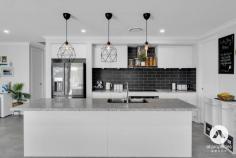 28 Hiddenvale Circuit Yarrabilba QLD 4207 Showcasing the perfect balance of modern design, family functionality, and premium features, this Coral home delivers a lifestyle of elegance and ease. Built in 2020 on a spacious 569m² elevated corner block, the residence blends thoughtful design with resort-style living, tailored for families who value both comfort and sophistication. Stepping inside, a smart entry lock and high 2550 ceilings create an immediate sense of luxury. The open-plan family living zone connects seamlessly to the gourmet kitchen, fitted with premium kitchen features including a 900mm oven, walk-in pantry, abundant storage, fridge plumbing, and a stone island bench. Indoor-outdoor entertaining is effortless, with sliding doors opening to a covered alfresco and a sparkling heated saltwater pool an oasis framed by enchanting pool lights, perfect for evening gatherings. Designed for versatile family living, the home offers multiple living zones including a private media room with sliding doors and direct yard access. Dual living zones make it easy to balance relaxation and entertainment, while the spacious master suite provides a private retreat with walk-in robe, versatile nook, and an expansive ensuite with double vanities and floor-to-ceiling tiles. Three additional bedrooms are equipped with mirrored robes, ceiling fans, and plush carpeting, ensuring comfort for all family members. Everyday practicality is enhanced with a separate laundry offering external access, a fully fenced low-maintenance backyard ideal for kids and pets, and eco-conscious inclusions such as a 6.6kw solar system, 3000L water tank, and ducted air conditioning. Security is assured with 8 wired cameras, while wall-mounted TV provisions elevate the home’s entertainment offering. Designed for modern families, this residence enjoys a peaceful street setting near everyday amenities. Property Features: • Built in 2020 on a 569m² elevated corner block, offering modern design and space for families. • Huge Family Home 307m2 living space • Gourmet kitchen with premium kitchen features including 900mm oven, walk-in pantry, fridge plumbing and stone benchtops. • Open-plan family living and dining designed for seamless indoor-outdoor entertaining. • Private media room with sliding doors for noise isolation and direct backyard access. • Expansive master suite with walk-in robe, ensuite featuring double vanities, floor-to-ceiling tiles, and a versatile nook ideal for home office, beauty station, or extra storage. • Three additional bedrooms with mirrored built-in robes and ceiling fans, offering comfort and functionality. • Heated 4x6m saltwater swimming pool with enchanting pool lighting, perfect for year-round enjoyment. • Covered alfresco entertaining area overlooking the pool, ideal for gatherings with family and friends. • Separate laundry with external access for added practicality. • Fully fenced, low-maintenance backyard providing a safe haven for children and pets. • Ducted air conditioning throughout ensuring year-round climate comfort • 6.6kw solar system for energy efficiency and cost savings. • 3000L water tank promoting sustainable living. • High 2550 ceilings throughout enhancing natural light and sense of space. • Wall mounts for TVs in multiple areas, designed for modern family living. • 8 wired security cameras installed, delivering peace of mind and enhanced protection. • Quiet street, near amenities walking distance to Parks, Schools, Shops and Childcare