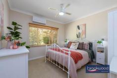 4 Narla Pl Koongamia WA 6056 $639,000 Nestled at the quiet end of a cul-de-sac, this charming 1950s cottage captures the essence of relaxed foothills living. Set on a generous 878-square-metre block with sub-divisible potential, the home is framed by cottage-style gardens that create an inviting sense of arrival. 3 bedrooms 1 bathroom 1959-built Fibro and tile Jarrah floor high ceiling OP kitchen/meals w AC Formal lounge w SC fire Freshly painted through Ducted evap + 2 splits 878 sqm block R20/35 Shed/storage/OS parking A pathway travels through established plantings to the welcoming front verandah of this impressive Koongamia home. Inside, original jarrah floors and high ceilings speak to the home’s heritage, creating spaces that feel both gracious and grounded. The formal lounge, anchored by a slow combustion fire fitted into the original fireplace, offers a cosy retreat, its large west-facing window framing leafy garden views. A sliding door connects this room to the open-plan kitchen and meals area, where white and grey cabinetry, a freestanding electric oven and split-system air conditioning combine to create a bright, functional hub for daily living. A door opens from the kitchen to the front verandah, introducing an easy indoor-outdoor flow perfect for casual alfresco dining as the day winds down. To the rear of the kitchen, a generously proportioned walk-through laundry leads to a wide east-facing verandah overlooking cottage gardens, blossom and trees that fill the backyard with seasonal colour. The principal bedroom is situated at the front of the home, where generous proportions, a picture window, and a lofty ceiling create an airy, light-filled retreat. Garden views through the window bring a sense of calm, while carpet underfoot and split-system air conditioning ensure year-round comfort. Two additional bedrooms offer flexible accommodation. The rear room features an east-facing window with garden aspects, while the second junior bedroom provides ample space for a double bed. Both bedrooms have polished jarrah floors. The shared family bathroom has been thoughtfully updated with full tiling, a walk-in shower, vanity and built-in storage, while a separate WC adds practical convenience. Beyond the back door, the property reveals its authentic charm. The rear garden is a generous, sun-dappled space where mature trees offer shade and cottage-style plantings soften the boundaries. It’s the kind of yard that invites weekend mornings with a book, summer barbecues and the simple pleasure of watching the seasons change. The Heritage Trail runs along the side boundary, offering hours of walking and riding amidst the natural beauty of the Perth Hills. The top-of-the-cul-de-sac position ensures peace and privacy without sacrificing accessibility. Koongamia strikes a rare balance – a foothills suburb with genuine character, and practical access to Midland, public transport and Perth Airport, keeping the city within easy reach. This cottage embodies that balance perfectly: original charm and modern convenience, generous gardens and subdivisible potential, quiet comfort and connected living. For those seeking a character home with flexibility, space and a location that truly delivers, this is an opportunity worth seizing.