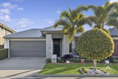 12 Kumbatine Street Pimpama QLD 4209 Welcome to 12 Kumbatine Street, a beautifully presented Plantation Homes build that perfectly blends modern comfort with family-friendly living in the heart of Gainsborough Greens. Built in 2018 and set on a 375m² block, this home has been thoughtfully designed to suit the busy lifestyle of Queensland families who value both style and convenience. Step inside and you’ll immediately feel the sense of space created by impressive 2.7m ceilings and hybrid flooring that flows through the open plan design. The gourmet kitchen, complete with stone benchtops, a 900mm cooktop, oven, and a walk-in pantry, is a dream for anyone who loves to cook or entertain. Overlooking the dining and living areas, the space seamlessly connects to the covered alfresco, making it easy to enjoy indoor-outdoor living and hosting all year round. Families will love the separate kids’ retreat, a bonus second living area that keeps everyone connected but gives the little ones their own space. All four bedrooms are fitted with built-in robes, while the master bedroom offers the luxury of a walk-in robe. The bathrooms have been designed with everyday families in mind, featuring stone benchtops and double vanities for that extra touch of elegance. Practicality hasn’t been overlooked either, with split system air-conditioning, a double garage, and the unbeatable convenience of being within walking distance to shops, schools, and everything that makes Gainsborough Greens such a sought-after area. Key Features – 375m² block built by Plantation Homes in 2018 – 4 bedrooms with built-in robes, master with walk-in robe – Open plan living and dining flowing to alfresco – Separate kids’ retreat for flexible family living – Kitchen with 900mm appliances, stone benchtops, and walk-in pantry – Bathrooms with double vanities and stone finishes – 2.7m ceilings and hybrid flooring throughout – Split system air-conditioning and double garage – Walking distance to local shops and schools This home is all about lifestyle-modern, low-maintenance, and ready for you to simply move in and enjoy.
