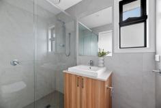 1/3 Lorna Street Seaford VIC 3198 $730,000 - $800,000 Cleverly designed to create a masterful combination of space, light, and detail, this dual-level home boldly delivers a low-maintenance luxury with its recently finished interiors that feature quality finishes, open living areas, and energy-efficient solutions. Employing tasteful contrast and warm timber tones, the first of just three homes introduces its private living spaces with an open-plan social domain featuring space for living and dining alongside a hard-working kitchen featuring modern stainless steel appliances, stone benchtops with a breakfast bar overhang, and functional storage options. A timber staircase unites the four bedrooms and three bathrooms, cascading across both levels to present adaptable living arrangements, with dual master suites each featuring a premium carpet and private ensuite. Accompanied by a ground floor powder room and a double garage with rear laundry facilities, the home includes multiple split-system heating/cooling units throughout, elevated ceiling heights, clothesline, rear garden shed, rain water storage, and a landscaped frontage with secure boundaries. Enjoy total convenience, with close proximity to Seaford Beach, Kananook Train Station, Bayside Shopping Centre, and Peninsula Link access.