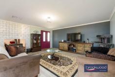 33 Tamarillo Ct Bakers Hill WA 6562 $949,000 An as-new Colorbond steel framed home set on 3.26 acres of park-like acreage planted with deciduous trees for shade, natives for wildlife habitat and jacarandas for summer colour. This property delivers genuine space – inside and out – with a three-bedroom primary residence, separate one-bedroom accommodation, two paddocks and the kind of big sky that reminds you what evening light actually looks like. Reclaimed materials meet contemporary country style throughout, from Art Deco leadlight windows to repurposed farm machinery that lends structure to the garden. 3 bedrooms, 2 bathrooms Colorbond Queenslander home Open-plan kitchen/family/meals Fantastic activity/games room Generous interior spaces Wrap-around verandah Sep 1 × 1 accommodation 2 paddocks, sheds, chooks 3.26 level acres fenced 3-meter-wide verandahs The main residence sits proudly elevated, with reclaimed Art Deco leadlight windows screening the corners of the wraparound verandah. Entry is via a wide staircase framed by multicoloured recycled paving. The thoughtful reuse continues—an old bedhead repurposed as a balustrade, and disused farm machinery cleverly lending structure to garden beds. An inspired material palette and a clear eye for making things work give this home genuine personality. The open-plan kitchen, family, and meals area feels genuinely spacious. A 900 mm freestanding self-cleaning oven anchors the kitchen, finished in soft blue cabinetry with marble-look benchtops and a grey subway-tile splashback. Hybrid flooring runs across the entire plan, connecting kitchen to meals to family room in a continuous flow that makes the space feel larger than its footprint and handles the inevitable traffic of daily life without complaint. The meals area opens directly to the southern verandah – breakfast outside becomes routine, not an occasion. A large casement opening and double-sided Jarrahdale slow-combustion fire, with a pressed-metal surround, link the central living area to the adjoining activity room. Timber floors and generous proportions make this a great, open space where a pool table fits comfortably, creating a laid-back spot for family fun, entertaining and unwinding together. The principal suite claims the front corner of the plan, a bay window framing views across the acreage. The room is generous – king-size bed, space for a reading chair, split-system air conditioning, and direct deck access. The ensuite features a relaxing spa bath, a detail that transforms a standard evening into a genuine wind-down. Two junior bedrooms share the family bathroom – one a double, the other a large king with reverse-cycle air conditioning and its own deck access. The family bathroom includes both a shower and a tub, with a separate WC accessed via the walk-through laundry. The laundry itself uses a moody palette, continuing the contemporary country aesthetic that runs throughout. The separate accommodation elevates this property. A large verandah with outdoor blinds leads to a multi-use room with a pitched roof, slow-combustion fire, evaporative cooling, and a kitchen corner. This space could serve as additional accommodation for visiting family, a teenager’s retreat that offers everyone breathing room, or a home-based business office /showroom. A sheltered outdoor fire pit extends the usable space – somewhere to gather on clear nights when the stars do all the talking. The large bathroom/laundry and partially enclosed rear room (ideal as bedroom or office) add genuine flexibility. Outside, the 3.26 acres delivers fenced paddocks – one with shelter – provide scope for a pony, alpacas, or simply the peace that comes with room to breathe and move. The chicken coop is in place. A woodshed, garden shed, carport, and an old bus converted to a storage room. The property runs a 5-kW solar array and connects to scheme water, supplemented by a small rainwater tank. The acreage itself has been planted with trees for shade and jacarandas that announce summer in violet. The garden incorporates recycled elements throughout – a creative approach that gives the property character. Bakers Hill township sits five minutes away – enough distance to feel separate, close enough that milk runs don’t become expeditions. Northam is 20 minutes, Mundaring 25 minutes, Perth Airport approximately 50 minutes. This is the Wheatbelt fringe – close enough to Perth for work commutes, far enough out that the night sky actually matters. The property suits anyone seeking space without isolation, contemporary comfort without suburban compression and the particular satisfaction of hearing birdsong rather than traffic as the day begins.