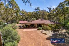 3865 Alice Rd Mount Helena WA 6082 $1,100,000 Positioned at the summit of nearly five acres of natural bushland, this substantial family residence offers discerning buyers an exceptional opportunity to craft their ideal Perth Hills lifestyle. The home presents a thoughtfully conceived floor plan that balances formal elegance with relaxed family living, all set against captivating bush vistas, with space for everyone to live, laugh, learn, and grow. 4 bedrooms 2 bathrooms 2004-built brick and tile Sep study/home office Formal lounge/media rm Split-level open plan living 13 x 9 workshop 3 phase Large outdoor alfresco Fenced, gated dual access 4.95-acre/2-hectare block Habitat for humans & wildlife The home’s elevated position commands attention from the moment you arrive, with double front doors opening to reveal a welcoming foyer that sets an elegant tone. To one side, the formal lounge/media room unfolds as a sophisticated retreat – defined by an arching glass wall and bathed in eastern light, this room frames mesmerising views of the surrounding bushland, creating an inspiring space for quiet reflection or sophisticated entertaining. From the central hallway, a dedicated home office provides the perfect work-from-home solution, offering separation from the main living areas without isolation from family life. Beyond lies the true heart of the residence: a spectacular open plan family, meals and living zone that celebrates the energy and spontaneity of modern family living. Soaring ceilings with exposed beams amplify the sense of space, whilst generous windows flood the interior with natural light and draw the eye outward to the landscape. A sunken family room adds architectural interest and creates natural zones within the expansive room, while the slow-combustion fire provides both warmth and ambience during cooler months. The family-sized kitchen anchors one corner of this central hub, featuring a practical U-shaped bench configuration, a convenient shoppers’ entry from the carport, and a corner pantry for ample storage. This is a kitchen designed for daily life – functional, accessible, and perfectly positioned at the centre of family activity. The home’s considered design continues with a seamless indoor-outdoor flow to an extensive south-east-facing entertaining area. This sheltered outdoor zone significantly extends the living space, creating an ideal setting for year-round gatherings, from casual weekend barbecues to memorable celebrations with friends and family. The accommodation is cleverly zoned for family life. A separate junior wing houses two queen and one double sized bedrooms, each with ceiling fans and robe recesses, served by a family bathroom, a walk-in linen press, and a walk-through laundry with a separate WC. This layout provides children or guests with their own territory. In contrast, the principal suite occupies a private position at the front of the home. This substantial retreat features split-system air conditioning for year-round comfort, an open ensuite with a large corner tub and a separate shower, and a walk-in robe with abundant storage. It’s a genuine parents’ sanctuary that doesn’t compromise on space or amenity. Beyond the residence, the fenced and gated two-hectare site is predominantly natural bushland, providing habitat for native wildlife and delivering a spectacular seasonal wildflower display that connects residents with the rhythms of the natural environment. The established trees and native vegetation create a private, peaceful setting that feels a world away from urban life. A separate access point leads to a 13m x 9 m high-clearance Colorbond workshop. Equipped with three-phase power, a concrete floor, and a mezzanine storage area, this versatile structure accommodates serious hobbies, home-based businesses, or extensive storage needs. Two water tanks harvest rainwater from both the workshop and residence, supporting sustainable living and providing excellent water security. Sold on an as-is basis, the home offers an honest opportunity for buyers seeking excellent bones and a solid framework to personalise and update according to their vision and budget. The floor plan, positioning, and infrastructure are all in place – the canvas awaits your creative input. Mount Helena offers the ideal balance of rural tranquillity and accessible convenience. The township provides essential services. Families benefit from proximity to primary and secondary schools. Mundaring is within easy reach, providing comprehensive shopping, dining, medical services, and recreational amenities. The location delivers genuine Perth Hills living without sacrificing connection to essential services.