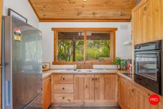 23 Strawhorn Court Kyneton VIC 3444 $950,000 - $1,045,000 If you've ever pictured yourself waking up to water views, wandering through and sipping coffee, watching kangaroos, as the morning mist lifts off the dam, this is your moment. From every room, there's a view worth framing, mesmerising outlooks that shift with the light, from rippling reflections on the water to the lush greens of the garden. You'll hardly need artwork when nature's doing the job for you. Inside, the cabin wraps you in warmth and charm. Think cove timber-lined ceilings, polished concrete floors and that wonderful mix of rustic texture and relaxed style. A crackling wood heater in the lounge sets the tone for winter nights, while split system heating and cooling keeps things perfectly comfortable year-round. The kitchen enjoys the same calming outlook, making every meal a moment to savour. The living spaces invite you to slow down, settle in and soak up the peace. Outside, it's pure magic. Expansive lawns down to the water's edge, incorporating beautiful established European shade trees and gardens that create a sense of timeless calm. Behind the dam, a pocket of bushland invites an easy afternoon wander for nature lovers or a playground for children, with the dam itself alive with yabbies and turtles, and spaces for collecting wood for the fire, family and friend gatherings, or quiet nights under the star-filled skies by the fire-pit. There's shedding with a carport, a woodshed, water tanks and solar, everything you need to live comfortably and lightly. It's relaxed, it's inviting and it's got that rare kind of charm that feels like a deep breath out. Whether it's your weekend hideaway or your forever escape, this one's all heart.