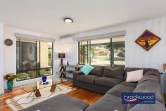 9 Gannon Glen Mundaring WA 6073 $1,399,999 Set beneath the generous canopy of a mature tree, this family home demonstrates how considered design can accommodate the evolving rhythms of domestic life. The architecture employs a disciplined material palette – blackbutt and ceramic tile flooring, soft greys and whites across walls and high ceilings, modern neutrals in the Matrix kitchen – to create a coherent spatial narrative that balances formality with ease in an accessible, adaptable design. 4 bed 2 bath and study 2000-built Guardian home Central open plan design Formal lounge & dining Expansive principal suite Resort-style alfresco & Spa 9m x 18m workshop 5kW solar & auto retic 2003 sqm landscaped block East-facing verandah The plan is organised around a central open-plan living zone, with formal and informal spaces at its heart and a clear separation of private realms: junior bedrooms occupy one wing, the principal suite the other. This zoning extends outdoors, where the interior flows seamlessly to an alfresco area beneath a timber-lined gable roof. The approach is through a terraced front garden enclosed by low fencing. An east-facing verandah leads to the entry, where double doors open onto a tiled foyer. Blackbutt floors define the formal lounge and dining rooms, continuing through to a home office with wraparound desk – positioned to overlook the private rear garden – and into the northern wing’s principal suite. Dual-aspect glazing draws natural light deep into the formal spaces, amplifying the restrained tonal palette. A sliding door reveals the home’s central living zone: a light-filled kitchen, meals and activity area beneath high ceilings, detailed with wainscoting and serviced by split and ducted air conditioning. A slow-combustion fireplace anchors the space. Porcelain tiles flow across the kitchen and meals area, giving way to carpet in a panelled TV room that opens to the east-facing verandah – an ideal spot for morning coffee. The kitchen is finished in soft mushroom cabinetry with Caesarstone benchtops that echo this neutral tone. Appliances include a new steam oven, an electric cooktop and a dishwasher. A bay window frames views to the outdoor entertaining area, accessible through double doors that open to an alfresco zone, spa and a timber-decked gazebo around a central lawn. The junior wing demonstrates a restrained approach to material and colour. White walls and grey tones establish a calm atmosphere across three carpeted bedrooms, each with built-in storage. The bathroom is fitted to spa standard, with a soaking tub, walk-in shower and brass tapware. Even the laundry – equipped with fitted washer and dryer – has been considered as part of the home’s coherent aesthetic. At the northern end, the principal suite comprises a bedroom with blackbutt flooring, a generous ensuite with an accessible shower and a separate WC, and a fitted walk-in wardrobe. A sliding door opens directly onto a private paved patio – a secluded outdoor room screened from view. External stairs descend to a substantial 9m x 18m workshop at the rear, a separate storage room and a high-clearance carport. Accessed via a side driveway, the space is configured for workshop use or secure storage of larger vehicles. A ramp allows for step-free access to the gardens and shed. The property combines well-proportioned living areas, both formal and relaxed, with considered outdoor spaces for entertaining and retreat. A timber-framed workshop, automatic reticulation and 5kW solar array add practical value. High-specification finishes throughout reflect an attention to detail that extends from material selection to presentation. Minutes from the heart of Mundaring, within walking distance of schools and ideally situated for weekends spent exploring the trails and sights of the Perth Hills, this family home accommodates the full spectrum of domestic life.