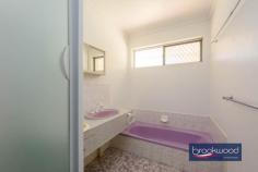 24 Bellevue Rd Bellevue WA 6056 $725,000 This solid 1975 brick-and-tile home sits on a generous 680-square-metre block zoned R20/40, offering immediate liveability with genuine potential for those who see beyond the mauve bathroom tiles. The bones are good, the layout works, and there’s space to move – both inside and out. A powered workshop, substantial verandah, and private backyard complete a package that rewards practical thinking. 4 bedrooms, 1 bathroom 1975-built brick and tile Well-proportioned living Open-plan kitchen meals 6 m x 6 m powered shed Private fenced backyard 16 m x 3 m rear verandah Drive through BY access Zoned R20/40, 680 sqm lot 15 minutes to Perth airport The formal entry from the tandem carport leads through an arched doorway into an air-conditioned lounge room that’s surprisingly light and well-proportioned. Timber-look floors underfoot and a picture window overlooking the backyard create an airy feel that belies the home’s modest street presence. The open-plan kitchen and meals area continue the functional approach. Timber-look cabinetry, laminated benchtops, and an integrated breakfast bar define the cooking zone, which is fitted with an electric oven, new dishwasher, never used and a built-in pantry. Nothing revolutionary, but everything you need is here and sensibly arranged. The meals area accommodates a proper dining table with room to move, and the outlook to the backyard makes morning coffee feel less rushed than it probably is. Four carpeted bedrooms branch off a central hallway in classic 70s fashion. The main bedroom comes with air-conditioning, a ceiling fan, and a wardrobe, providing a comfortable retreat. One of the junior rooms includes a robe recess. The shared family bathroom embraces its era with mauve fixtures and tiles that someone, somewhere, is now paying premium prices to recreate. A separate WC sits off the walk-through laundry, a practical arrangement that eliminates morning bathroom queues. The backyard is where this property distinguishes itself. Double gates at the rear of the tandem carport provide drive-through access to a 6-metre by 6-metre powered workshop tucked into one corner – a space serious enough for projects, storage, or tinkering. A row of trimmed fiddlewood trees lines the rear boundary, their canopies creating a green screen that erupts with fragrant flowers come spring. The fully fenced lawn extends from an 16-metre verandah running the full width of the home’s rear, providing multiple zones for outdoor living. Palm trees frame a partially enclosed gazebo that previously housed a spa but reads more readily as an outdoor kitchen in waiting. Add a barbecue, some string lights, and comfortable seating, and you’ve created the kind of entertaining space that keeps people outside long after the sun sets. The privacy here is genuine – the kind where neighbours exist but don’t dominate your sightlines. The R20/40 zoning adds another dimension to the proposition. For those who see this as a long-term hold, there’s development potential. For those who want space now, the 680-square-metre block delivers elbow room. The location offers practical advantages too – Perth Airport sits roughly 15 minutes away via direct highway access, making early flights less punishing than they might be from elsewhere. This isn’t a home that will seduce you with European appliances or Instagram-ready interiors. It’s a solid, honest property that works now and offers options for later. The reward here is space – to live, to work, to potentially develop – at a point where space itself has become a luxury. For buyers who value function over fashion and see potential where others see only bathrooms that time forgot, this represents genuine opportunity.