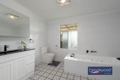 33 Tamarillo Ct Bakers Hill WA 6562 $949,000 An as-new Colorbond steel framed home set on 3.26 acres of park-like acreage planted with deciduous trees for shade, natives for wildlife habitat and jacarandas for summer colour. This property delivers genuine space – inside and out – with a three-bedroom primary residence, separate one-bedroom accommodation, two paddocks and the kind of big sky that reminds you what evening light actually looks like. Reclaimed materials meet contemporary country style throughout, from Art Deco leadlight windows to repurposed farm machinery that lends structure to the garden. 3 bedrooms, 2 bathrooms Colorbond Queenslander home Open-plan kitchen/family/meals Fantastic activity/games room Generous interior spaces Wrap-around verandah Sep 1 × 1 accommodation 2 paddocks, sheds, chooks 3.26 level acres fenced 3-meter-wide verandahs The main residence sits proudly elevated, with reclaimed Art Deco leadlight windows screening the corners of the wraparound verandah. Entry is via a wide staircase framed by multicoloured recycled paving. The thoughtful reuse continues—an old bedhead repurposed as a balustrade, and disused farm machinery cleverly lending structure to garden beds. An inspired material palette and a clear eye for making things work give this home genuine personality. The open-plan kitchen, family, and meals area feels genuinely spacious. A 900 mm freestanding self-cleaning oven anchors the kitchen, finished in soft blue cabinetry with marble-look benchtops and a grey subway-tile splashback. Hybrid flooring runs across the entire plan, connecting kitchen to meals to family room in a continuous flow that makes the space feel larger than its footprint and handles the inevitable traffic of daily life without complaint. The meals area opens directly to the southern verandah – breakfast outside becomes routine, not an occasion. A large casement opening and double-sided Jarrahdale slow-combustion fire, with a pressed-metal surround, link the central living area to the adjoining activity room. Timber floors and generous proportions make this a great, open space where a pool table fits comfortably, creating a laid-back spot for family fun, entertaining and unwinding together. The principal suite claims the front corner of the plan, a bay window framing views across the acreage. The room is generous – king-size bed, space for a reading chair, split-system air conditioning, and direct deck access. The ensuite features a relaxing spa bath, a detail that transforms a standard evening into a genuine wind-down. Two junior bedrooms share the family bathroom – one a double, the other a large king with reverse-cycle air conditioning and its own deck access. The family bathroom includes both a shower and a tub, with a separate WC accessed via the walk-through laundry. The laundry itself uses a moody palette, continuing the contemporary country aesthetic that runs throughout. The separate accommodation elevates this property. A large verandah with outdoor blinds leads to a multi-use room with a pitched roof, slow-combustion fire, evaporative cooling, and a kitchen corner. This space could serve as additional accommodation for visiting family, a teenager’s retreat that offers everyone breathing room, or a home-based business office /showroom. A sheltered outdoor fire pit extends the usable space – somewhere to gather on clear nights when the stars do all the talking. The large bathroom/laundry and partially enclosed rear room (ideal as bedroom or office) add genuine flexibility. Outside, the 3.26 acres delivers fenced paddocks – one with shelter – provide scope for a pony, alpacas, or simply the peace that comes with room to breathe and move. The chicken coop is in place. A woodshed, garden shed, carport, and an old bus converted to a storage room. The property runs a 5-kW solar array and connects to scheme water, supplemented by a small rainwater tank. The acreage itself has been planted with trees for shade and jacarandas that announce summer in violet. The garden incorporates recycled elements throughout – a creative approach that gives the property character. Bakers Hill township sits five minutes away – enough distance to feel separate, close enough that milk runs don’t become expeditions. Northam is 20 minutes, Mundaring 25 minutes, Perth Airport approximately 50 minutes. This is the Wheatbelt fringe – close enough to Perth for work commutes, far enough out that the night sky actually matters. The property suits anyone seeking space without isolation, contemporary comfort without suburban compression and the particular satisfaction of hearing birdsong rather than traffic as the day begins.