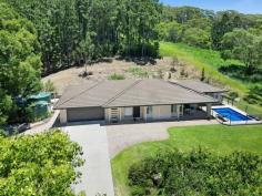 108 Piggabeen Road Currumbin Valley QLD 4223 $2,395,000 Idyllic Lifestyle: Acreage Serenity Meets Coastal Convenience - Sprawling across 2.05 acres of leafy serenity, this single level sanctuary offers a tranquil hinterland escape under ten minutes from famed surf break, Currumbin Alley. Set well back from the street and elevated to gaze out across the tree-lined landscape, it's comfortable, stylish and solidly built. Well-kept, with neutral-toned interiors, natural light flows effortlessly into the modern kitchen. Primed for everyday functionality or entertaining, with stainless-steel appliances and Caesarstone benches, it adjoins an expansive living and dining zone before flowing onto an alfresco terrace via bifold doors. Covered and capturing an outlook across the rolling greenery and sparkling pool, it's a calming outdoor oasis to gather with guests or relax. Family fun continues with movie nights in the media room, while rest and rejuvenation await in the four bedrooms. A tasteful ensuite and walk-in robe are lovely indulgences to enjoy in the master suite, complemented by a stylish main bathroom and a powder room. Outdoors, kids and pets can play under a vast canopy of mature shade trees or come together as a family to harvest exotic fruit from the thriving papaya, Hawaiian guava, black sapote, lime and lemon trees. Afterwards, cool off in the saltwater-magnesium pool – and with the added bonus of heating, it's perfect for year-round use! Additionally, practicalities continue with an oversized double garage with utility/ games area (and potential to be converted into a granny flat), solar panels, solar hot water and three interconnected water tanks with UV filter. Situated to deliver the best of both worlds, embrace a sweet and peaceful acreage escape only a short drive from essential amenities. Savour fresh, organic goodies at Pasture & Co, or browse the artisan boutiques at Currumbin Eco-Village in approx. 4 minutes; or benefit from the convenience of being a mere five minute drive to St. Augustine's Parish Primary or Currumbin Fair shops. Plus take your pick between cooling off at the picturesque Rockpools or Currumbin Beach – each within a tempting 10 minute radius. Experience first-hand the idyllic lifestyle that awaits – arrange your inspection today! House Features: Spacious single level residence, well presented with light-filled, neutral-toned interiors Set back from the street for enhanced serenity and elevated to enjoy a lush outlook Modern kitchen with stainless-steel appliances (including a 5-burner cooktop and Bosch dishwasher), walk-in pantry, Caesarstone benches and island Expansive living and dining area flows outside via bifold doors Media room with built-in Jensen speakers Master suite includes a walk-in and built-in robe, ensuite with double vanity and access to pool area Three bedrooms with built-in robes Tasteful main bathroom with shower, vanity and bath Powder room Covered alfresco terrace overlooks the pool and lush greenery Saltwater-magnesium pool with heating Laundry with storage and outdoor access Oversized double car garage with utility/games area (or potential granny flat) 9kW air-conditioning reverse cycyle system Ceiling fans Security screens on all sliding doors LED lighting 2.55m ceilings throughout Built with N3 cyclone rating Insulation to roof and sound insulation near kitchen, lounge room and powder room 5G internet Property Features: 2.05 acres of rolling greenery, with mature shade trees and fruit trees Garden maintenance and mowing contractor is happy to continue to maintaining the property for the new purchasers. Two solar hot water systems Six solar panels Three water tanks offering 48,000L storage, all linked with paper/carbon and UV filter Two sheds Envirocycle Fully irrigated Papayas, Hawaiian guava, black sapote (chocolate mousse), lime and lemon trees Location: Approx. 4 mins to Currumbin Eco-Village cafes and boutiques Approx. 5 min to St. Augustine's Parish Primary or IGA Currumbin Fair Approx. 9 min to Currumbin State School, Currumbin Alley or Currumbin Rockpools Approx. 14 mins to Burleigh Heads Approx. 15 mins to Gold Coast Airport Approx. 16 mins to Kirra Beach Approx. 32 mins to Surfers Paradise