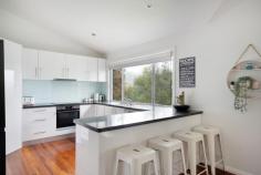 93A The Crescent Helensburgh NSW 2508 Set in a peaceful pocket of Helensburgh, 93a The Crescent presents a wonderful opportunity to secure a spacious home on a generous parcel of land, surrounded by privacy and a beautiful bush outlook. Set across 2 well designed levels, the home has been thoughtfully planned to offer both comfort and flexibility. The main living areas feature timber floors that create warmth and flow, while the bedrooms are finished with carpet for added comfort. All bedrooms include walk in robes, with the main bedroom enjoying its own ensuite complete with a large corner bath, creating a true parents retreat. Multiple living areas provide excellent separation for everyday living. Upstairs offers relaxed family living that opens seamlessly to a large undercover entertaining deck, perfect for hosting or unwinding while overlooking the fenced grassed yard. The bush outlook enhances the sense of calm and connection to nature, making the home feel like a private retreat. Downstairs, a large separate living or rumpus room adds exceptional versatility. This space could easily be used as a fourth bedroom, teenagers retreat, in law accommodation or home office, and is supported by a separate toilet for added convenience. Parking for 2 cars ensures practicality, while the generous land size provides breathing room that is increasingly hard to find. With its flexible layout, peaceful setting and strong connection to the outdoors, this is a home that adapts beautifully to different stages of life. A standout opportunity for buyers seeking space, privacy and a relaxed lifestyle in one of Helensburgh's most tightly held streets. Property Highlights Set across 2 spacious levels Beautiful bush outlook with excellent privacy Timber floors to main living areas 3 large bedrooms, all with walk in robes, main with ensuite and large corner bath Multiple living areas offering excellent separation Large separate downstairs living or rumpus room with potential for 4th bedroom Large undercover entertaining deck Location is key here, with the property a short drive to the Helensburgh Train Station, making it perfect for commuters looking for an easy 50-minute journey into Sydney. Location Highlights Picturesque Stanwell Park Beach is less than 10 minutes drive. The Royal National Park is within a 10 minute drive with easy access to numerous hiking trails and swimming spots. Short drive to Helensburgh CBD with supermarket, numerous cafes and restaurants and specialty store. Easy walk to Helensburgh train station with a convenient 50 minute commute to the city This is one of the only remaining areas where you can find a peaceful regional lifestyle less than an hour from Sydney. It offers all of those charming lifestyle benefits that one would associate with small town living:- bushwalking, swimming holes, bike tracks, sporting clubs, cafes and of course plenty of friendly people.