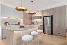 1/5 Wazir St Bardwell Valley NSW 2207 $1,800,000 - $1,900,000 Family Duplex Showcases Rare Refinement with Contemporary Style and Comfort Clever design and elegant finishes have created a family living environment of undeniable class and comfort in this sleek, as-new duplex. Making an instant impression from the street, the striking two-tone brick facade is accented with hanging greenery and landscaped gardens. Stepping inside, the effortless sense of style continues with timber flooring, tall ceilings and sleek on-trend appointments, while the prime north west to rear aspect ensures superb natural lighting throughout. There are up to five bedrooms to cater for growing families, with a gourmet gas kitchen and multiple alfresco settings adding immense appeal for entertainers. Quietly positioned but still close to everything you could need, this magnificent home is just 250 metres from Athelstane Public School and 400 metres from Arncliffe Park and playground. There's also easy walking access to two different train lines - a 900 metre stroll will take you to Turrella Station, and Arncliffe's main street shopping strip and station are both 1.1 kilometres away. • Engineered timber floors and high shadowline ceilings • Modern design fuses living, dining and kitchen spaces • Tall sliding glass doors ensure seamless flow to terrace • Barbecue kitchenette for easy all-weather entertaining • Sunny level lawn leads to raised carport/alfresco setting • Sophisticated stone island kitchen features gas cooktop • Four upper bedrooms with robes, ground floor fifth/study • Main has dual rain shower ensuite, desk, private balcony • Balcony captures elevated outlooks over neighbourhood • Refined family bathrooms on both floors, one with bath • Ducted a/c, abundance of storage including under stairs • Rear lane access to secure paved carport from Gipps St • Carport offers great versatility as extra entertaining area • 500m to Wollongong Rd village, 1km to Forest Rd shops • 1.1km to waterside parklands and trails along Wolli Creek • 2km to Wolli Creek's dining precinct, station, Woolworths