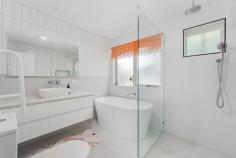 18 Balmerino Square Frankston VIC 3199 $980,000 - $1,060,000 Set in a serene, tree-lined court in Frankston, this expansive double-storey home is designed for growing families, multi-generational living, or anyone who craves space, character, and flexible entertaining. With three generously sized bedrooms, a dedicated home office or fifth bedroom, and multiple indoor and outdoor living zones, it seamlessly combines warmth, charm, and functionality across a sprawling layout. At the heart of the home, the kitchen offers a five-burner gas cooktop, wall-mounted oven, double sink, breakfast bar, and garden-view window, ideal for home cooks or entertainers. Adjacent to the kitchen, the dining room glows under a skylight and includes a feature bar, perfect for hosting family and friends. The large vaulted family room and separate lounge showcase beautiful wood detailing, slate tiling, and natural light streaming through oversized windows. The upstairs master suite is a true retreat with private balcony access, walk-in robe, air conditioning, and a spacious ensuite with double vanity and oversized shower. Downstairs, three additional bedrooms include built-in robes, mirrored storage, timber floors, and garden outlooks, while a stylish main bathroom features a freestanding tub, rainfall shower, and quality fixtures. The separate home office with built-in robe and window is ideal for remote workers or quiet study. Outside, the property unfolds into beautifully landscaped gardens with multiple alfresco options. Enjoy outdoor meals under the covered patio, relax in the central BBQ courtyard, or retreat to the private sauna for an end-of-day escape. A stone pathway winds through lush garden beds and mature greenery, adding a tranquil feel throughout. Practicality is covered with a full-size laundry, split system air conditioning, double carport, two sheds (including a cubby-style space), and a large rumpus/games room that connects to both the front and rear of the property. Situated within easy reach of local schools, parks, shopping precincts and transport, this unique property delivers a rare blend of charm, scale, and indoor-outdoor lifestyle in a tightly held Frankston pocket.