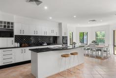 2D Willcath Street Bulli NSW 2516 A statement in luxury family living, this expansive East Bulli home offers exceptional space, multiple living areas, and high-quality finishes throughout. Designed for comfort and entertaining, it features generously proportioned rooms and a layout that effortlessly balances elegance with relaxed coastal living. Just a short walk from the sand, it combines the privacy and tranquility of a premium location with easy access to Bulli Beach and local amenities. YOUR HOME • Designed for modern family living, this impressive home immediately feels both grand and welcoming, offering a wonderful sense of space while remaining warm and inviting. Light-filled interiors, generous proportions, and soaring spaces create an airy, open atmosphere throughout, balancing a commanding presence with relaxed coastal comfort. Multiple indoor and outdoor living zones, along with soft natural tones and seamless flow, enhance the home's breezy, easy-living appeal, making it perfect for both everyday family life and effortless entertaining. • The home has been thoughtfully updated in recent years to enhance comfort and style. A contemporary kitchen sits at the heart of the home, complemented by a rendered exterior, ducted air conditioning throughout, and a recently upgraded hot water system, all contributing to a polished residence that feels fresh, bright and effortlessly coastal. • The kitchen and living spaces open seamlessly to the rear patio, creating an ideal setting for alfresco meals or relaxed gatherings with friends, while children play in the sun-filled backyard. Unwind as you take in the surrounding gardens or sink into the warmth of the outdoor spa. • The spacious backyard provides a wonderful backdrop for making lasting family memories, whether it's watching kids and pets enjoy the open lawn or sharing a quiet glass of wine beneath the stars. • Featuring 4/5 generously sized bedrooms and 3 bathrooms, this home offers comfort and luxury for family living and entertaining. The master bedroom is exceptionally spacious and includes a large ensuite with a bath that looks out onto a private, leafy outlook, offering a serene retreat. A striking electric fire adds warmth and indulgence, making this bedroom a true sanctuary. • A side path from the property offers a direct route to the beach in under ten minutes, a coveted seaside advantage. • An oversized three-car garage provides secure, off-street parking for multiple vehicles, plus plenty of space for boards, bikes, and other gear, offering both convenience and peace of mind.. LOCATION • This home is situated in what is quickly becoming one of the most popular positions in the Northern Illawarra. Only moments from the pristine Bulli Beach, local ocean pools, fantastic cafes, parks, schools including Bulli High School, and shops. • Bulli is a charming and peaceful coastal suburb, just over 1 hour South of Sydney CBD and approximately 15 minutes North of Wollongong CBD. • Embrace coastal living with swimming, fishing, bushwalking and picnics in popular parklands all available only moments from your doorstep. Exceptional properties like this do not stay on the market for long. Enquire now!