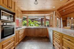 18 Balmerino Square Frankston VIC 3199 $980,000 - $1,060,000 Set in a serene, tree-lined court in Frankston, this expansive double-storey home is designed for growing families, multi-generational living, or anyone who craves space, character, and flexible entertaining. With three generously sized bedrooms, a dedicated home office or fifth bedroom, and multiple indoor and outdoor living zones, it seamlessly combines warmth, charm, and functionality across a sprawling layout. At the heart of the home, the kitchen offers a five-burner gas cooktop, wall-mounted oven, double sink, breakfast bar, and garden-view window, ideal for home cooks or entertainers. Adjacent to the kitchen, the dining room glows under a skylight and includes a feature bar, perfect for hosting family and friends. The large vaulted family room and separate lounge showcase beautiful wood detailing, slate tiling, and natural light streaming through oversized windows. The upstairs master suite is a true retreat with private balcony access, walk-in robe, air conditioning, and a spacious ensuite with double vanity and oversized shower. Downstairs, three additional bedrooms include built-in robes, mirrored storage, timber floors, and garden outlooks, while a stylish main bathroom features a freestanding tub, rainfall shower, and quality fixtures. The separate home office with built-in robe and window is ideal for remote workers or quiet study. Outside, the property unfolds into beautifully landscaped gardens with multiple alfresco options. Enjoy outdoor meals under the covered patio, relax in the central BBQ courtyard, or retreat to the private sauna for an end-of-day escape. A stone pathway winds through lush garden beds and mature greenery, adding a tranquil feel throughout. Practicality is covered with a full-size laundry, split system air conditioning, double carport, two sheds (including a cubby-style space), and a large rumpus/games room that connects to both the front and rear of the property. Situated within easy reach of local schools, parks, shopping precincts and transport, this unique property delivers a rare blend of charm, scale, and indoor-outdoor lifestyle in a tightly held Frankston pocket.