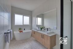 34 Brushtail Rd Nar Nar Goon VIC 3812 $900,000 - $990,000 Why endure the wait of building when you can step straight into a brand-new, fully turnkey residence today? Beautifully positioned within the prestigious Ridgelea Estate, this exceptional home delivers a refined blend of contemporary design, intelligent functionality and effortless, low-maintenance living—perfectly suited to families or discerning buyers seeking a seamless lifestyle upgrade. Thoughtfully designed for both comfort and sophistication, the home comprises four generous bedrooms, including an elegant master suite complete with a beautifully appointed ensuite and spacious walk-in robe. The remaining bedrooms are fitted with built-in robes and are serviced by a stylish central bathroom. At the heart of the residence, a designer kitchen makes a striking statement, showcasing premium appliances, an expansive island bench and a substantial walk-in pantry. This culinary hub overlooks the open-plan living and dining domain, creating a natural gathering space for everyday living and entertaining alike. A second living zone provides flexibility for growing families, offering the perfect setting for relaxation or a private retreat. Seamless indoor-outdoor integration is achieved with a covered alfresco area under the roofline, extending the living space and providing an inviting environment for year-round entertaining. Outdoors, the property is fully landscaped and complemented by quality window furnishings, ensuring a complete, move-in-ready experience. Comfort is assured throughout the seasons with zoned heating and cooling, while a double garage with internal access enhances everyday convenience. Designed with meticulous attention to detail and finished in a modern, sophisticated palette, this impressive residence presents an outstanding opportunity to secure a premium home in a highly regarded estate—ready to move in and enjoy from day one.