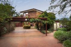 18 Balmerino Square Frankston VIC 3199 $980,000 - $1,060,000 Set in a serene, tree-lined court in Frankston, this expansive double-storey home is designed for growing families, multi-generational living, or anyone who craves space, character, and flexible entertaining. With three generously sized bedrooms, a dedicated home office or fifth bedroom, and multiple indoor and outdoor living zones, it seamlessly combines warmth, charm, and functionality across a sprawling layout. At the heart of the home, the kitchen offers a five-burner gas cooktop, wall-mounted oven, double sink, breakfast bar, and garden-view window, ideal for home cooks or entertainers. Adjacent to the kitchen, the dining room glows under a skylight and includes a feature bar, perfect for hosting family and friends. The large vaulted family room and separate lounge showcase beautiful wood detailing, slate tiling, and natural light streaming through oversized windows. The upstairs master suite is a true retreat with private balcony access, walk-in robe, air conditioning, and a spacious ensuite with double vanity and oversized shower. Downstairs, three additional bedrooms include built-in robes, mirrored storage, timber floors, and garden outlooks, while a stylish main bathroom features a freestanding tub, rainfall shower, and quality fixtures. The separate home office with built-in robe and window is ideal for remote workers or quiet study. Outside, the property unfolds into beautifully landscaped gardens with multiple alfresco options. Enjoy outdoor meals under the covered patio, relax in the central BBQ courtyard, or retreat to the private sauna for an end-of-day escape. A stone pathway winds through lush garden beds and mature greenery, adding a tranquil feel throughout. Practicality is covered with a full-size laundry, split system air conditioning, double carport, two sheds (including a cubby-style space), and a large rumpus/games room that connects to both the front and rear of the property. Situated within easy reach of local schools, parks, shopping precincts and transport, this unique property delivers a rare blend of charm, scale, and indoor-outdoor lifestyle in a tightly held Frankston pocket.
