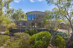 130 Mountain Bay Drive Mountain Bay VIC 3723 $950,000 - $1,030,000 Set in a peaceful, elevated position and designed to embrace its breathtaking surrounds, this architecturally appealing four bedroom, two bathroom residence captures sweeping lake and mountain views from multiple vantage points. The expansive upstairs master retreat is a true sanctuary, complete with a private Juliet balcony and oversized windows that frame the water below and leafy treetops beyond - an idyllic space to wake with the changing light and unwind in total privacy. Downstairs, light filled open plan living, kitchen, and dining areas flow seamlessly to a generous entertaining deck where mornings begin with birdsong and a quiet cuppa, and evenings are spent soaking in the tranquil outlook. A second living zone provides flexibility for families, guests, or a dedicated retreat for children, enhancing the home's functionality for both holidaymakers and permanent residents alike. Outdoors, a second rear deck is nestled among established ornamental trees, with meandering garden paths inviting you to explore the landscaped surrounds. A separate vegetable garden offers the opportunity for sustainable living, while boating enthusiasts will appreciate the convenience of being just minutes from a private launch, only 1km to the Mountain Bay members only concrete boat ramp with deep water access and no crowds. Perfectly positioned just 5 minutes from Goughs Bay, 20 minutes to Mansfield, and 40 minutes to the Mt Buller Resort entry, this exceptional property delivers the ultimate lifestyle - whether as a serene holiday escape or a full time home immersed in nature. Features You'll Love: Upstairs master retreat offering private living space, with the 4th bedroom as a flexible option Open plan living, kitchen, and dining area flowing seamlessly to outdoor entertaining decks Dedicated laundry with outdoor access from the kitchen, providing extra storage Second living area ideal for children, guests, or a quiet retreat Split system heating and cooling to both upstairs and downstairs zones for year round comfort Wood heater for cosy winter warmth Ceiling fans throughout to enhance airflow and comfort Beautifully established gardens with ornamental plantings and meandering pathways Separate vegetable garden with storage shed for sustainable living Four large water tanks providing excellent water storage capacity Option to purchase fully furnished for a ready to enjoy move in or holiday rental Just minutes from private lake access and 5 minutes to the Goughs Bay Boat Club Close proximity to Mansfield and just 30 minutes to Mt Buller Resort entry Don't miss this rare opportunity to secure your own lakeside sanctuary - whether as a tree change, holiday escape, or high yield rental.