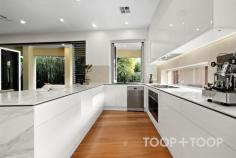 25 Jetty St Grange SA 5022 At 25 Jetty Street, Grange, everyday life is shaped by proximity to the water—walking distance to the stunning shoreline of Grange Beach, and equally close to local cafes and eateries. Architecturally designed c.2010 and set on a north-facing 560sqm allotment, this four-bedroom residence is planned around light, comfort, and a strong connection between interior living zones and a deliberately low-maintenance outdoors. The home’s pool setting is central to its lifestyle appeal: a solar-heated inground swimming pool is paired with a cabana, decked leisure area, and outdoor shower, creating an outdoor arrangement that reads as purposeful and easy to use. A spacious alfresco extends the entertaining footprint further, featuring an outdoor barbeque area and an automatic outdoor blind—practical inclusions that make the space adaptable across changing weather and long lunches that run into the evening. Inside, the kitchen continues the home’s emphasis on function and finish, with Smeg appliances anchoring the main cooking zone. Warm timber floors and expansive glass doors seamlessly connect the open-plan living and dining areas to the outdoor spaces. A work from home office or luxe guest bedroom adds flexibility on the ground floor, complemented by a cosy gas fireplace set into a stone feature wall—an inviting focal point for quieter months or visiting friends. Also on the ground level, the master bedroom is positioned as a true retreat: built-in robes, a modern ensuite, with poolside views and direct access for morning swims or easy outdoor living. A wine cellar adds a considered touch for collectors and entertainers alike, while a powder room and laundry on this level support day-to-day flow without complication. Upstairs, a large living area offers a second zone for relaxation, with discreet kitchen facilities that make it ideal for shared living arrangements or guests. Two generous bedrooms with built-in robes are supported by a bathroom and an additional powder room, reinforcing the home’s practical planning. Features we love • Architecturally designed c.2010 four-bedroom home on a north-facing 560sqm allotment • Solar-heated inground pool with cabana, decked leisure area, and outdoor shower • Spacious alfresco with outdoor Weber kitchen and automatic outdoor blind • Lounge/guest bedroom with gas fireplace and stone feature wall • Ground-floor master with modern ensuite, built-in robes, and poolside access • Double garaging with internal home access and built in shelving • Ducted reverse cycle air conditioning, plus evaporative cooling • Environmentally conscience with 5.5kw solar panels and 13,500ltr underground water tank plumbed to toilets and garden irrigation system • Large upper-level living area with kitchenette Location Highlights Lifestyle and Convenience Just footsteps from the sands of Grange Beach, the Grange Hotel, Jetty and iconic Jetty Café with a plethora of local cafes and amenities within an easy walk. Education Zoned for Grange Primary and Seaton High School with additional schooling options including, Star of the Sea, Fulham Gardens Primary, Fulham North Primary, Elizabeth O’Grady Kindergarten, St. Michael’s College, and more.