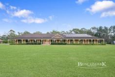 1239 Coral Avenue KENTLYN NSW 2560 Set on a stunning five-acre parcel of level, usable land, this property offers a rare opportunity to enjoy space, privacy and a relaxed lifestyle surrounded by nature. With peaceful surroundings, open skies and the soothing sounds of birds, this property delivers the perfect balance of rural charm and comfortable family living. The home has been thoughtfully designed to provide generous living spaces and effortless indoor-outdoor flow, with newly renovated kitchen and living areas creating a fresh, modern hub for the home. Perfect for both everyday living and entertaining, the layout offers multiple spaces for the family to relax and enjoy the lifestyle this property has to offer. Property Features: • Four bedrooms, all with built-in robes and ceiling fans • Master bedroom with large ensuite featuring double vanity • Spacious main bathroom with separate sink area, shower, bath and toilet • New carpet throughout bedrooms • Renovated modern kitchen with stone benchtops, induction cooking, walk-in pantry and window overlooking the property grounds • Open plan kitchen, living and dining area with wood fireplace and stunning timber-lined ceiling • Additional front living room • Renovated laundry with outdoor access • Ducted zoned air conditioning throughout • Huge undercover outdoor entertaining area connecting to wrap-around veranda • Double lock-up garage with additional kitchen and toilet – ideal for potential dual living • Impressive five-acre block with large shed positioned at the rear • Three separate paddocks suitable for livestock • Dam located on the property • Peaceful location surrounded by nature and birdlife