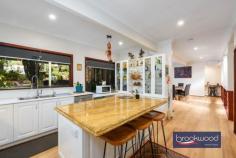 17 Duncan Pl Mahogany Creek WA 6072 $1,300,000 There are Hills properties, and then there are Hills homes – the kind shaped by years of considered care, where every corner reflects a deliberate choice to showcase its qualities. Set at the end of a private cul-de-sac in one of the Darling Range’s most quietly coveted pockets, this solid jarrah-and-iron character home has thoughtfully evolved into something genuinely special: a split-level family sanctuary that balances privacy with connection, liveability with style and character with charm. 4 bedrooms, 2 bathrooms 1989-built jarrah & iron Spacious split-level design Fantastic cooks’ kitchen First-floor parents’ retreat Stunning outdoor room Powered 6 x 9m workshop Auto retic, Solar and RC SS 1800 sqm landscaped lot Trails, schools, transport close The home’s two-storey design oozes style and is set across several levels, with a floor plan that gives each member of the household room to breathe. From the sealed and kerbed driveway – flanked by rock-retained gardens and a water-feature atrium – the entry opens upstairs to a generous parents’ retreat and primary suite, or steps down through the heart of the home toward the rear. It’s the kind of house you feel yourself settle into as you move through. The parents’ level is its own domain: a formal lounge or sitting room alongside the primary bedroom, cocooned yet connected by muted tones and plantation shutters featuring built in robes and a spa ensuite. Downstairs, three large junior bedrooms each include storage options; the largest “the Wood Room” is framed by a large picture window and opens through French doors to a private deck overlooking the bush reserve beyond – the sort of room a teenager never wants to leave. They share a neat family bathroom featuring a bath, shower, vanity and a separate WC. At the centre of the home, a magnificent kitchen anchors daily life with purpose. A granite-topped island bench with breakfast bar and second sink overlooks the atrium and patio; glass-fronted display cabinets, ample storage, a plumbed fridge, and a dedicated workstation make this a kitchen that takes cooking – and family life – seriously. A Neff double oven, Miele dishwasher, and Asko cooktop complete the picture. The adjoining laundry – calm, considered, with built-in storage – carries the same design conviction and flows seamlessly. Stepping down to the vast family living area, high raked ceilings and large picture windows create a sense of openness. A slow-combustion fire anchors winter evenings; Reverse cycle split system air-conditioning manages the summer months. French doors connect the living room to a spectacular outdoor room – with a span roof, sub-floor insulation, retractable screens, and remote-controlled doors on either side fashion an all-season space for gatherings large and small. Behind the home, a powered 6m x 9m Colorbond workshop with a 6m x 3m covered bay awaits the enthusiast, tradie, or hobbyist, with limited vehicle access through the rear reserve. Two water tanks supply fresh rain water to the home, automatic reticulation system currently running on scheme water, that sustains the extensive native gardens and sweeping lawn, which, along with rock walls and meandering pathways, cross the generous 1,800 sqm block. Mahogany Creek sits quietly in the Hills, a community with a deep connection to its surroundings. The Heritage Trail runs close by, and a bush reserve backs directly onto the property. Families are well-served by a strong selection of schools – Mundaring Primary, Darlington Primary, and Eastern Hills and Swan View Senior High Schools are all within easy reach. Mundaring Village – with its cafés and community facilities – is a comfortable 10-minute drive; Midland city centre is approximately 20 minutes. Perth CBD is about 45 minutes away, and Perth Airport is roughly a 35-minute drive – making this a genuine Hills address that doesn’t require you to sacrifice the city entirely. For families looking for a home to grow into – one with space, soul and surroundings to match – this one is hard to look past.