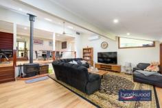 17 Duncan Pl Mahogany Creek WA 6072 $1,300,000 There are Hills properties, and then there are Hills homes – the kind shaped by years of considered care, where every corner reflects a deliberate choice to showcase its qualities. Set at the end of a private cul-de-sac in one of the Darling Range’s most quietly coveted pockets, this solid jarrah-and-iron character home has thoughtfully evolved into something genuinely special: a split-level family sanctuary that balances privacy with connection, liveability with style and character with charm. 4 bedrooms, 2 bathrooms 1989-built jarrah & iron Spacious split-level design Fantastic cooks’ kitchen First-floor parents’ retreat Stunning outdoor room Powered 6 x 9m workshop Auto retic, Solar and RC SS 1800 sqm landscaped lot Trails, schools, transport close The home’s two-storey design oozes style and is set across several levels, with a floor plan that gives each member of the household room to breathe. From the sealed and kerbed driveway – flanked by rock-retained gardens and a water-feature atrium – the entry opens upstairs to a generous parents’ retreat and primary suite, or steps down through the heart of the home toward the rear. It’s the kind of house you feel yourself settle into as you move through. The parents’ level is its own domain: a formal lounge or sitting room alongside the primary bedroom, cocooned yet connected by muted tones and plantation shutters featuring built in robes and a spa ensuite. Downstairs, three large junior bedrooms each include storage options; the largest “the Wood Room” is framed by a large picture window and opens through French doors to a private deck overlooking the bush reserve beyond – the sort of room a teenager never wants to leave. They share a neat family bathroom featuring a bath, shower, vanity and a separate WC. At the centre of the home, a magnificent kitchen anchors daily life with purpose. A granite-topped island bench with breakfast bar and second sink overlooks the atrium and patio; glass-fronted display cabinets, ample storage, a plumbed fridge, and a dedicated workstation make this a kitchen that takes cooking – and family life – seriously. A Neff double oven, Miele dishwasher, and Asko cooktop complete the picture. The adjoining laundry – calm, considered, with built-in storage – carries the same design conviction and flows seamlessly. Stepping down to the vast family living area, high raked ceilings and large picture windows create a sense of openness. A slow-combustion fire anchors winter evenings; Reverse cycle split system air-conditioning manages the summer months. French doors connect the living room to a spectacular outdoor room – with a span roof, sub-floor insulation, retractable screens, and remote-controlled doors on either side fashion an all-season space for gatherings large and small. Behind the home, a powered 6m x 9m Colorbond workshop with a 6m x 3m covered bay awaits the enthusiast, tradie, or hobbyist, with limited vehicle access through the rear reserve. Two water tanks supply fresh rain water to the home, automatic reticulation system currently running on scheme water, that sustains the extensive native gardens and sweeping lawn, which, along with rock walls and meandering pathways, cross the generous 1,800 sqm block. Mahogany Creek sits quietly in the Hills, a community with a deep connection to its surroundings. The Heritage Trail runs close by, and a bush reserve backs directly onto the property. Families are well-served by a strong selection of schools – Mundaring Primary, Darlington Primary, and Eastern Hills and Swan View Senior High Schools are all within easy reach. Mundaring Village – with its cafés and community facilities – is a comfortable 10-minute drive; Midland city centre is approximately 20 minutes. Perth CBD is about 45 minutes away, and Perth Airport is roughly a 35-minute drive – making this a genuine Hills address that doesn’t require you to sacrifice the city entirely. For families looking for a home to grow into – one with space, soul and surroundings to match – this one is hard to look past.
