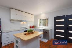12 Herbert St Toodyay WA 6566 $669,000 Positioned at the end of a cul-de-sac on the banks of the Avon River, this home is brimming with a sense of sanctuary. From the moment you arrive, the elevated northerly aspect, the dappled light through grand eucalypts lining the riverbank, and the easy rhythm of the river signal something genuinely special. Toodyay is one of the Avon Valley’s most-loved historic towns and this property captures everything that makes it so: a connection to the landscape, a pace that restores and a welcome that lingers long after you’ve left. 3 bedrooms 1 bathroom 1991-built Hardi and iron Open plan w SC fire & AC Reno’ed kitchen fresh paint New oven, sink & lighting Main bed with BI storage North-facing front patio Colorbond shed & fencing 1534 sqm with two titles Restful riverside sanctuary The heart of the home is its central open-plan living area – a generous, light-filled space where the kitchen and family room flow naturally into one another and, through glass doors, spill out onto a north-facing patio. A peppercorn tree sways in the breeze beyond the glass, and birds chatter and cavort along the river – it’s hard to imagine a more idyllic spot for an alfresco breakfast. In the evenings, the slow-combustion fireplace draws everyone in, casting an amber glow that makes a house feel like a home. A split-system air conditioner means the seasons shift outside without ever disrupting the comfort within. The kitchen has been thoughtfully updated. Shaker-style cabinetry brings a quiet elegance, and a cleverly designed extendable island does double duty as breakfast bar and preparation space – the kind of detail you appreciate on a slow Sunday morning with coffee in hand. A new dishwasher and freestanding oven complete a kitchen that is as practical as it is considered. All three bedrooms open off the central living area, keeping the floorplan connected and intuitive. The first – just off the kitchen – is perfectly proportioned for a nursery or a quiet guest room. The main bedroom is a genuinely restful space, fitted with a full-height wall of storage that keeps clutter out of sight and its own split-system air conditioning for personalised comfort through every season. The third bedroom completes a layout that adapts as readily to a young family as it does to those seeking a weekend base or a considered downsize. A walk-through laundry connects the living areas to a well-appointed family bathroom with shower, tub and vanity, a separate WC adds everyday practicality. Outside, a large lot enclosed by new Colorbond fencing offers privacy and real possibility: room for a vegetable garden, scheme water is connected, space for children or dogs to run, or simply the pleasure of owning a generous parcel of land in town. The generous 1534 sqm block on two titles (847 sqm and 687 sqm) provides room to breathe, and the R10/50 zoning offers future flexibility. Whether you’re seeking a weekend escape a short drive from Perth, a rural lifestyle for your young family, or downsizing from a working farm while remaining in a country setting, this property offers an exceptional opportunity. The Colorbond shed, with secure rooms flanking a central open bay, adds practical storage or workshop space; the chicken coop holds the promise of freshly-laid eggs for breakfast. Toodyay’s history remains a living part of its modern identity. This home sits within walking distance of the town centre – a well-serviced country hub with supermarket, pubs, a much-loved bakery and independent shops. The town has become a popular destination for weekend breaks and day trips, with vintage car clubs among its regular visitors. During the Avon Descent, the river becomes a focal point for the community and visitors alike. The historic streetscapes, with their carefully preserved buildings and character, tell stories of the pastoral era, whilst the Avon River continues to shape the landscape and lifestyle of this enduring settlement.