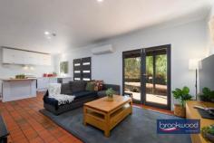 12 Herbert St Toodyay WA 6566 $669,000 Positioned at the end of a cul-de-sac on the banks of the Avon River, this home is brimming with a sense of sanctuary. From the moment you arrive, the elevated northerly aspect, the dappled light through grand eucalypts lining the riverbank, and the easy rhythm of the river signal something genuinely special. Toodyay is one of the Avon Valley’s most-loved historic towns and this property captures everything that makes it so: a connection to the landscape, a pace that restores and a welcome that lingers long after you’ve left. 3 bedrooms 1 bathroom 1991-built Hardi and iron Open plan w SC fire & AC Reno’ed kitchen fresh paint New oven, sink & lighting Main bed with BI storage North-facing front patio Colorbond shed & fencing 1534 sqm with two titles Restful riverside sanctuary The heart of the home is its central open-plan living area – a generous, light-filled space where the kitchen and family room flow naturally into one another and, through glass doors, spill out onto a north-facing patio. A peppercorn tree sways in the breeze beyond the glass, and birds chatter and cavort along the river – it’s hard to imagine a more idyllic spot for an alfresco breakfast. In the evenings, the slow-combustion fireplace draws everyone in, casting an amber glow that makes a house feel like a home. A split-system air conditioner means the seasons shift outside without ever disrupting the comfort within. The kitchen has been thoughtfully updated. Shaker-style cabinetry brings a quiet elegance, and a cleverly designed extendable island does double duty as breakfast bar and preparation space – the kind of detail you appreciate on a slow Sunday morning with coffee in hand. A new dishwasher and freestanding oven complete a kitchen that is as practical as it is considered. All three bedrooms open off the central living area, keeping the floorplan connected and intuitive. The first – just off the kitchen – is perfectly proportioned for a nursery or a quiet guest room. The main bedroom is a genuinely restful space, fitted with a full-height wall of storage that keeps clutter out of sight and its own split-system air conditioning for personalised comfort through every season. The third bedroom completes a layout that adapts as readily to a young family as it does to those seeking a weekend base or a considered downsize. A walk-through laundry connects the living areas to a well-appointed family bathroom with shower, tub and vanity, a separate WC adds everyday practicality. Outside, a large lot enclosed by new Colorbond fencing offers privacy and real possibility: room for a vegetable garden, scheme water is connected, space for children or dogs to run, or simply the pleasure of owning a generous parcel of land in town. The generous 1534 sqm block on two titles (847 sqm and 687 sqm) provides room to breathe, and the R10/50 zoning offers future flexibility. Whether you’re seeking a weekend escape a short drive from Perth, a rural lifestyle for your young family, or downsizing from a working farm while remaining in a country setting, this property offers an exceptional opportunity. The Colorbond shed, with secure rooms flanking a central open bay, adds practical storage or workshop space; the chicken coop holds the promise of freshly-laid eggs for breakfast. Toodyay’s history remains a living part of its modern identity. This home sits within walking distance of the town centre – a well-serviced country hub with supermarket, pubs, a much-loved bakery and independent shops. The town has become a popular destination for weekend breaks and day trips, with vintage car clubs among its regular visitors. During the Avon Descent, the river becomes a focal point for the community and visitors alike. The historic streetscapes, with their carefully preserved buildings and character, tell stories of the pastoral era, whilst the Avon River continues to shape the landscape and lifestyle of this enduring settlement.