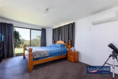 374 Mayo Rd Gidgegannup WA 6083 $1,250,000 Almost fifty acres of bush and open parkland form the setting for this extraordinary land holding in the Perth Hills, approached via a long driveway that winds through scattered eucalypts before cresting to a well-maintained shed home and outbuildings and a cleared building envelope of around 7.1 acres – the highest point of the property. The existing accommodation offers genuine comfort and practicality while you plan a permanent residence that meets the demands of this exceptional site. 3 beds, 1 bath, 2 WCs Shome RC/AC + SC fire Bright well-maintained Family room, study nook Main bed semi en suite Bore & rainwater tanks Pwd shed/teens retreat Workshop, AC & hoist 49.47-acre lot fully fenced Incomparable Hills views The opportunity to build on a site of this quality is uncommon enough; to do so with comfortable three-bedroom accommodation, powered outbuildings for storage and work, an established orchard and a chicken run already in place is rarer still. The view from the building envelope is genuinely arresting. A canopy of eucalypts runs to the east, layer upon layer of green giving way to distant ridges that shift colour through the day as the light moves across them. Wedge-tailed eagles ride the thermals above, dark shapes tracing slow arcs across an open sky, and grass trees, some centuries old, punctuate the margins of the clearing like sentinels that have watched this country through everything. The existing home has been recently updated, with fresh paint, a new wall oven, and split AC units. Three bedrooms, a study nook, a combined kitchen and meals area, a family room, a bathroom and two separate WCs provide all the essentials without pretension. The family room anchors the living spaces with a slow-combustion fireplace that will carry the house through a Hills winter with ease, and the newly paved north- and east-facing verandah extends the living area into the landscape, making the view a daily participant in domestic life rather than an occasional backdrop. The main bedroom benefits from semi-en-suite access to the bathroom – a practical arrangement that suits the building’s scale well. Air conditioning serves the main living zones and bedrooms, and the overall presentation is clean and considered: this is a functional base from which the property’s larger project can be planned and monitored in comfort. Beyond the shed home, the property’s operational infrastructure is substantial. A powered shed doubles as a teens’ retreat or gym. A separate high-clearance workshop is fitted with evaporative cooling, a mezzanine and a vehicle hoist, making it a serious asset whether you’re building, running a home business, or simply keeping on top of 49.47 acres. The almost fifty acres is perimeter-fenced, and water security is well considered. A bore and 100,000 litres of rainwater tank capacity feed the home, and the surrounding lawn, chicken coop and enclosed orchard are reticulated – a meaningful foundation for whatever comes next, whether that is an expanded garden or an orchard extension. A mixture of open grassed parkland and native bush gives the property both its expansive character and its ecological richness. Kangaroos, echidnas, parrots and cockatoos move through the land with the ease of creatures entirely at home here – the kind of daily encounter with wildlife that is increasingly difficult to find within reach of the city. For families, the space offers something harder to quantify but no less real: room for children to grow, play, learn and explore on their own terms, in a landscape that rewards curiosity. Privacy is as close to absolute as this proximity to Perth allows. A single neighbour is briefly visible on the drive in – after that, the property is entirely its own world. Properties that combine scale, outlook and infrastructure of this order are genuinely rare. 49.47 acres, a building envelope of this quality and everything already in place to live and work comfortably from day one is a unicorn proposition. Views like this are finite by their nature; there is only so much high ground, and this is some of the best of it.