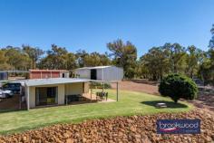 374 Mayo Rd Gidgegannup WA 6083 $1,250,000 Almost fifty acres of bush and open parkland form the setting for this extraordinary land holding in the Perth Hills, approached via a long driveway that winds through scattered eucalypts before cresting to a well-maintained shed home and outbuildings and a cleared building envelope of around 7.1 acres – the highest point of the property. The existing accommodation offers genuine comfort and practicality while you plan a permanent residence that meets the demands of this exceptional site. 3 beds, 1 bath, 2 WCs Shome RC/AC + SC fire Bright well-maintained Family room, study nook Main bed semi en suite Bore & rainwater tanks Pwd shed/teens retreat Workshop, AC & hoist 49.47-acre lot fully fenced Incomparable Hills views The opportunity to build on a site of this quality is uncommon enough; to do so with comfortable three-bedroom accommodation, powered outbuildings for storage and work, an established orchard and a chicken run already in place is rarer still. The view from the building envelope is genuinely arresting. A canopy of eucalypts runs to the east, layer upon layer of green giving way to distant ridges that shift colour through the day as the light moves across them. Wedge-tailed eagles ride the thermals above, dark shapes tracing slow arcs across an open sky, and grass trees, some centuries old, punctuate the margins of the clearing like sentinels that have watched this country through everything. The existing home has been recently updated, with fresh paint, a new wall oven, and split AC units. Three bedrooms, a study nook, a combined kitchen and meals area, a family room, a bathroom and two separate WCs provide all the essentials without pretension. The family room anchors the living spaces with a slow-combustion fireplace that will carry the house through a Hills winter with ease, and the newly paved north- and east-facing verandah extends the living area into the landscape, making the view a daily participant in domestic life rather than an occasional backdrop. The main bedroom benefits from semi-en-suite access to the bathroom – a practical arrangement that suits the building’s scale well. Air conditioning serves the main living zones and bedrooms, and the overall presentation is clean and considered: this is a functional base from which the property’s larger project can be planned and monitored in comfort. Beyond the shed home, the property’s operational infrastructure is substantial. A powered shed doubles as a teens’ retreat or gym. A separate high-clearance workshop is fitted with evaporative cooling, a mezzanine and a vehicle hoist, making it a serious asset whether you’re building, running a home business, or simply keeping on top of 49.47 acres. The almost fifty acres is perimeter-fenced, and water security is well considered. A bore and 100,000 litres of rainwater tank capacity feed the home, and the surrounding lawn, chicken coop and enclosed orchard are reticulated – a meaningful foundation for whatever comes next, whether that is an expanded garden or an orchard extension. A mixture of open grassed parkland and native bush gives the property both its expansive character and its ecological richness. Kangaroos, echidnas, parrots and cockatoos move through the land with the ease of creatures entirely at home here – the kind of daily encounter with wildlife that is increasingly difficult to find within reach of the city. For families, the space offers something harder to quantify but no less real: room for children to grow, play, learn and explore on their own terms, in a landscape that rewards curiosity. Privacy is as close to absolute as this proximity to Perth allows. A single neighbour is briefly visible on the drive in – after that, the property is entirely its own world. Properties that combine scale, outlook and infrastructure of this order are genuinely rare. 49.47 acres, a building envelope of this quality and everything already in place to live and work comfortably from day one is a unicorn proposition. Views like this are finite by their nature; there is only so much high ground, and this is some of the best of it.