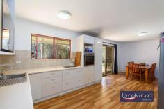 374 Mayo Rd Gidgegannup WA 6083 $1,250,000 Almost fifty acres of bush and open parkland form the setting for this extraordinary land holding in the Perth Hills, approached via a long driveway that winds through scattered eucalypts before cresting to a well-maintained shed home and outbuildings and a cleared building envelope of around 7.1 acres – the highest point of the property. The existing accommodation offers genuine comfort and practicality while you plan a permanent residence that meets the demands of this exceptional site. 3 beds, 1 bath, 2 WCs Shome RC/AC + SC fire Bright well-maintained Family room, study nook Main bed semi en suite Bore & rainwater tanks Pwd shed/teens retreat Workshop, AC & hoist 49.47-acre lot fully fenced Incomparable Hills views The opportunity to build on a site of this quality is uncommon enough; to do so with comfortable three-bedroom accommodation, powered outbuildings for storage and work, an established orchard and a chicken run already in place is rarer still. The view from the building envelope is genuinely arresting. A canopy of eucalypts runs to the east, layer upon layer of green giving way to distant ridges that shift colour through the day as the light moves across them. Wedge-tailed eagles ride the thermals above, dark shapes tracing slow arcs across an open sky, and grass trees, some centuries old, punctuate the margins of the clearing like sentinels that have watched this country through everything. The existing home has been recently updated, with fresh paint, a new wall oven, and split AC units. Three bedrooms, a study nook, a combined kitchen and meals area, a family room, a bathroom and two separate WCs provide all the essentials without pretension. The family room anchors the living spaces with a slow-combustion fireplace that will carry the house through a Hills winter with ease, and the newly paved north- and east-facing verandah extends the living area into the landscape, making the view a daily participant in domestic life rather than an occasional backdrop. The main bedroom benefits from semi-en-suite access to the bathroom – a practical arrangement that suits the building’s scale well. Air conditioning serves the main living zones and bedrooms, and the overall presentation is clean and considered: this is a functional base from which the property’s larger project can be planned and monitored in comfort. Beyond the shed home, the property’s operational infrastructure is substantial. A powered shed doubles as a teens’ retreat or gym. A separate high-clearance workshop is fitted with evaporative cooling, a mezzanine and a vehicle hoist, making it a serious asset whether you’re building, running a home business, or simply keeping on top of 49.47 acres. The almost fifty acres is perimeter-fenced, and water security is well considered. A bore and 100,000 litres of rainwater tank capacity feed the home, and the surrounding lawn, chicken coop and enclosed orchard are reticulated – a meaningful foundation for whatever comes next, whether that is an expanded garden or an orchard extension. A mixture of open grassed parkland and native bush gives the property both its expansive character and its ecological richness. Kangaroos, echidnas, parrots and cockatoos move through the land with the ease of creatures entirely at home here – the kind of daily encounter with wildlife that is increasingly difficult to find within reach of the city. For families, the space offers something harder to quantify but no less real: room for children to grow, play, learn and explore on their own terms, in a landscape that rewards curiosity. Privacy is as close to absolute as this proximity to Perth allows. A single neighbour is briefly visible on the drive in – after that, the property is entirely its own world. Properties that combine scale, outlook and infrastructure of this order are genuinely rare. 49.47 acres, a building envelope of this quality and everything already in place to live and work comfortably from day one is a unicorn proposition. Views like this are finite by their nature; there is only so much high ground, and this is some of the best of it.