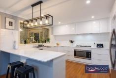 6 Gibbings St Northam WA 6401 $949,000 There are homes you walk into and immediately start imagining your life there – where the kids would sleep, where you’d have your morning coffee, what Sunday afternoons might look like. This is one of them. A large, well-built brick-and-iron family home sitting on a generous 3,475 sqm corner block with two street frontages, zoned R30 – meaning the picture here isn’t only about the present – It’s about what this place is right now, and what it can become. 5 bed 2 bath 3 WC Zoned for development Open plan living zone Renovated kitchen Renovated bathrooms Games room & pool Powered workshop Solar & scheme water R30 – 3,475 sqm block Corner dual frontage The entry hall is the first clue. It’s large and unhurried, the kind of scale that tells you something about everything that follows. To the right, the principal suite – east-facing, freshly carpeted with a plush textured pile and fitted with a walk-in robe. The ensuite is fully tiled, finished in soft, calm tones and tucked behind a barn-hung door. It’s a room that’s easy to be in. Quiet. Settled. The kitchen, family room and meals area occupy the middle of the home, where most of daily life will happen. The kitchen has been properly updated – stone benchtops, white soft-close cabinetry, a 900mm oven, gas hob and dishwasher. A slow-combustion fireplace anchors one end of the room. A split-system handles all seasons. Doors open to the alfresco area, and a north-facing window frames the pool. On a winter afternoon with the fire going, this room makes a strong case for itself. Three carpeted bedrooms for the kids, each with built-in robes, share a bathroom that’s been renovated in a similar vein to the ensuite – calm finishes, full tiling, a tub. A walk-through laundry sits nearby. The layout of this part of the home is straightforward and practical. Step outside, and the scale of the block starts to make itself known. The entertaining area is paved and looks over the pool and gazebo, with a built-in BBQ for good measure. The games room adjoins the pool directly – air-conditioned, bar-equipped, big enough for a pool table. Beside the gazebo, a separate structure houses a third WC and dedicated storage for pool equipment. It’s the kind of setup that makes you think about summer differently. Through a rear gate, and with vehicle access via a side lane, is a powered and plumbed 8 m x 8 m workshop with a lean-to. A small garden offers additional storage space. The current owners call the long stretch of open lawn along the Byfield Street frontage “the oval” and on weekends it earns the name with games, kick-to-kick and backyard cricket. It’s also the most obvious place to start a conversation about what this block could look like in ten years. With R30 zoning and two street frontages, the development potential (STCA) is straightforward and real. The land is there. The zoning is there. The rest is timing. There’s a version of this property that looks exactly as it does today – full of a family who never want to leave. There’s another version that looks quite different in ten or fifteen years. This home asks you to think about both – and gives you enough room, in every sense, to answer that question on your own terms.