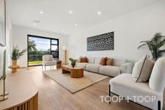 96A Reid Ave Magill SA 5072 $1,680,000 Welcome to 96A Reid Avenue, an extraordinary corner-block residence in the heart of Magill, South Australia. Bathed in natural light and defined by refined modern design, this home offers an immediate sense of calm, space, and understated elegance. Set within one of Adelaide’s most tightly held eastern suburbs, it delivers a sophisticated family lifestyle with architectural excellence, generous proportions, and effortless livability throughout. As you approach, the sleek exterior with its soft neutral tones offers a glimpse of the beauty within. Upon entering, you are greeted by a spacious lounge that flows effortlessly into an open-plan living and dining area. This space is framed by large windows, ensuring every corner is bathed in natural light. The home is thoughtfully designed with three distinct living areas, providing flexibility for everyday living, entertaining, and relaxation. The ground floor features a beautifully appointed master suite with walk-in robe and ensuite, offering privacy and comfort—ideal for guests, extended family, or multi-generational living. Upstairs continues the sense of space and functionality, featuring a second master retreat with walk-in robe, ensuite, and bathtub. Four additional upstairs bedrooms complete the accommodation, including three with built-in robes and one bedroom (adjacent to the balcony) without a built-in robe, offering flexibility as a study or additional living space. This level is further enhanced by a private balcony aspect, a well-appointed central bathroom, and an upstairs retreat with a built-in bar, including provisions for a fridge and tap—creating the perfect space for entertaining, relaxing, or hosting guests. At the heart of the home, the open-plan kitchen, living, and dining zone connects seamlessly to the outdoor entertaining area and rear yard, complete with artificial lawn and a private putting green—delivering a low-maintenance yet highly enjoyable lifestyle setting. The kitchen, a chef’s dream, boasts top-of-the-line appliances, high-end stone benchtops together with a statement stone island bench elevate the kitchen with timeless style and practicality. A standout feature of the home is the fully integrated whole-house filtered water system, providing purified water to every tap throughout the property, including bathrooms and showers. Perfectly located close to quality schools, parks, shopping precincts, cafés, and public transport, this exceptional residence presents a rare opportunity in a tightly held eastern suburbs pocket. Key features: -Constructed with rendered brick throughout, the home offers a solid build, excellent durability, and an elegant contemporary finish -Corner-block residence set on approximately 452sqm -Total living area approximately 364sqm -Ground-floor master suite with walk-in robe and ensuite -Upstairs master suite with walk-in robe, ensuite, and bathtub -Four additional upstairs bedrooms, three with built-in robes -Private balcony aspect from upstairs level -Upstairs retreat with built-in bar (fridge & tap provisions) -Three separate living areas including upstairs retreat -Gourmet kitchen with quality appliances and stone island bench -Open-plan living and dining area flowing to outdoor entertaining -Impressive 3-metre high ceilings downstairs creating a grand sense of space and natural light -Low-maintenance backyard with artificial lawn and private putting green -Fully integrated whole-house filtered water system -Security alarm system -Three-phase power for enhanced electrical capacity -13.2KW solar panel system with 27KW battery storage -Instantaneous gas hot water system -Secure double garage complete with panel lift entry and high-quality epoxy floors, alongside additional off-street parking for family and guests -Conveniently located near quality schools and local amenities -Walking distance to public transport -Easy access to The Parade, Firle Plaza, and Adelaide CBD -Close proximity to parks, cafés, and recreational facilities Whether you’re seeking a luxurious family residence in Magill or an investment opportunity with strong long-term appeal, this exceptional home is perfectly positioned to meet your needs.