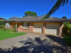 10A Main St Robertson NSW 2577 CENTRALLY LOCATED SPACIOUS HOME TO SUIT EVERYONE IN THE FAMILY ! First time on the market since built 1998, all the family will feel at home here with features to accomodate a myriad of interests. Set discreetly back from the street, the entrance portico opens out into a large formal living/dining room - or perhaps the 'parents' retreat. Step into the open plan kitchen, with long servery bench + loads of cupboards and adjacent informal dining area - or potential office spot - where the warmth of the enormous slow combustion fireplace will ensure the children are comfy in front of the wall mounted TV. The master bedroom with ensuite, walk-in-robe and bay window feature, is bathed in eastern light for your easy start to the morning. 3 other bedrooms are clustered around the main bathroom with separate shower & bath & completely separate toilet. For the gardener, the back yard boasts enclosed veggie beds ready to be rejuvenated and another fruit tree enclosure...with still plenty of room for outdoor entertaining under the covered nook just outside the kitchen windows or beside the large workshed/home hobbyist 'hideout'. Just the thing for a home gym, artist studio or 'kids' retreat' for peace and quiet. Many different varieties of flowering shrubs, amidst well established Tree Ferns, will delight all year round and add a layer of privacy to the perimeters. Other features include internal access to the double garage (which has a single roller door for access at the rear), internal laundry with external door to the clothes line, this home only needs 'your touch' for comfort and convenience for your family to grow in the community friendly atmosphere of Robertson village.