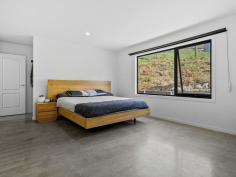 24B N Huon Rd Ranelagh TAS 7109 $795,000 Contemporary Luxury Meets the Charm of the Huon Valley Welcome to 24B North Huon Road, Ranelagh—an exceptional contemporary residence where thoughtful design, premium craftsmanship, and an enviable Huon Valley lifestyle come together in perfect harmony. Positioned on a generous 1,656m² elevated allotment and privately set back from the road, this stunning near-new home offers an outstanding opportunity to secure a quality-built residence in one of the Huon Valley's most sought-after locations. Combining architectural appeal with practical family living, every element has been carefully considered to create a home that is as beautiful as it is functional. From the moment you arrive, there is an unmistakable sense of privacy and tranquillity. Surrounded by established greenery and enjoying an elevated outlook, the home captures the peaceful atmosphere that makes Ranelagh such a desirable place to call home. Yet despite its secluded feel, you're only moments from the picturesque Huon River, the renowned Summer Kitchen Bakery, the popular Ranelagh Burger Bar, local parks and sporting facilities, with the township of Huonville only five minutes away and Hobart an easy scenic commute of approximately thirty minutes. Stepping inside, you'll immediately appreciate the quality and attention to detail showcased throughout the home. Polished concrete floors provide a striking first impression on the lower level, creating a sophisticated yet durable finish that perfectly complements the home's modern aesthetic. Natural textures, warm timber accents and an abundance of natural light combine to create interiors that feel both luxurious and welcoming. The lower level has been thoughtfully designed as a private family retreat. The spacious master suite offers a peaceful sanctuary, complete with a beautifully appointed ensuite and generous walk-in wardrobe. Two further bedrooms, each featuring built-in robes, provide comfortable accommodation for family members or guests. A stunning handcrafted timber staircase forms the centrepiece of the home, leading you upstairs where the residence truly comes to life. Bathed in natural light, the expansive open-plan living, dining and kitchen area has been designed to embrace modern family living and effortless entertaining. High ceilings and generous proportions create a wonderful sense of space. At the heart of the home lies a beautifully appointed kitchen that is certain to impress even the most discerning home chef. Combining style with exceptional functionality, it features expansive stone benchtops, quality appliances, an abundance of soft-close cabinetry, premium fixtures and fittings, and a spacious walk-in pantry that provides ample storage for growing families. Every detail has been thoughtfully selected to ensure the kitchen remains both a practical workspace and a striking focal point for the home. Also located on the upper level is a versatile fourth bedroom, serviced by a conveniently positioned separate toilet. The lifestyle extends well beyond the walls of the home. Timber stairs lead to an elevated entertaining area nestled at the top of the property, where a beautifully positioned fire pit creates the perfect setting for relaxed evenings under Tasmania's spectacular night skies. Gather with family and friends, toast marshmallows with the children, or simply unwind with a glass of local Huon Valley wine while taking in sweeping views across Ranelagh and glimpses of the Huon River winding through the valley below. The generous grounds offer endless possibilities for families, gardeners or those simply seeking space to breathe. There is ample room for children and pets to explore, opportunities to further landscape or personalise the property, and the freedom that comes with owning a substantial parcel of land in such a tightly held location. Living in Ranelagh means embracing one of Tasmania's most celebrated lifestyle destinations. Surrounded by rolling hills, orchards, vineyards and the beauty of the Huon Valley, you'll enjoy a true sense of community while remaining conveniently connected everyday amenities. Weekend adventures are never far away, whether you're exploring nearby walking trails, visiting local wineries, discovering artisan producers or simply enjoying the breathtaking natural beauty that surrounds you. This is an opportunity that is certain to impress the most discerning buyers and one that deserves your inspection.