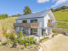24B N Huon Rd Ranelagh TAS 7109 $795,000 Contemporary Luxury Meets the Charm of the Huon Valley Welcome to 24B North Huon Road, Ranelagh—an exceptional contemporary residence where thoughtful design, premium craftsmanship, and an enviable Huon Valley lifestyle come together in perfect harmony. Positioned on a generous 1,656m² elevated allotment and privately set back from the road, this stunning near-new home offers an outstanding opportunity to secure a quality-built residence in one of the Huon Valley's most sought-after locations. Combining architectural appeal with practical family living, every element has been carefully considered to create a home that is as beautiful as it is functional. From the moment you arrive, there is an unmistakable sense of privacy and tranquillity. Surrounded by established greenery and enjoying an elevated outlook, the home captures the peaceful atmosphere that makes Ranelagh such a desirable place to call home. Yet despite its secluded feel, you're only moments from the picturesque Huon River, the renowned Summer Kitchen Bakery, the popular Ranelagh Burger Bar, local parks and sporting facilities, with the township of Huonville only five minutes away and Hobart an easy scenic commute of approximately thirty minutes. Stepping inside, you'll immediately appreciate the quality and attention to detail showcased throughout the home. Polished concrete floors provide a striking first impression on the lower level, creating a sophisticated yet durable finish that perfectly complements the home's modern aesthetic. Natural textures, warm timber accents and an abundance of natural light combine to create interiors that feel both luxurious and welcoming. The lower level has been thoughtfully designed as a private family retreat. The spacious master suite offers a peaceful sanctuary, complete with a beautifully appointed ensuite and generous walk-in wardrobe. Two further bedrooms, each featuring built-in robes, provide comfortable accommodation for family members or guests. A stunning handcrafted timber staircase forms the centrepiece of the home, leading you upstairs where the residence truly comes to life. Bathed in natural light, the expansive open-plan living, dining and kitchen area has been designed to embrace modern family living and effortless entertaining. High ceilings and generous proportions create a wonderful sense of space. At the heart of the home lies a beautifully appointed kitchen that is certain to impress even the most discerning home chef. Combining style with exceptional functionality, it features expansive stone benchtops, quality appliances, an abundance of soft-close cabinetry, premium fixtures and fittings, and a spacious walk-in pantry that provides ample storage for growing families. Every detail has been thoughtfully selected to ensure the kitchen remains both a practical workspace and a striking focal point for the home. Also located on the upper level is a versatile fourth bedroom, serviced by a conveniently positioned separate toilet. The lifestyle extends well beyond the walls of the home. Timber stairs lead to an elevated entertaining area nestled at the top of the property, where a beautifully positioned fire pit creates the perfect setting for relaxed evenings under Tasmania's spectacular night skies. Gather with family and friends, toast marshmallows with the children, or simply unwind with a glass of local Huon Valley wine while taking in sweeping views across Ranelagh and glimpses of the Huon River winding through the valley below. The generous grounds offer endless possibilities for families, gardeners or those simply seeking space to breathe. There is ample room for children and pets to explore, opportunities to further landscape or personalise the property, and the freedom that comes with owning a substantial parcel of land in such a tightly held location. Living in Ranelagh means embracing one of Tasmania's most celebrated lifestyle destinations. Surrounded by rolling hills, orchards, vineyards and the beauty of the Huon Valley, you'll enjoy a true sense of community while remaining conveniently connected everyday amenities. Weekend adventures are never far away, whether you're exploring nearby walking trails, visiting local wineries, discovering artisan producers or simply enjoying the breathtaking natural beauty that surrounds you. This is an opportunity that is certain to impress the most discerning buyers and one that deserves your inspection.